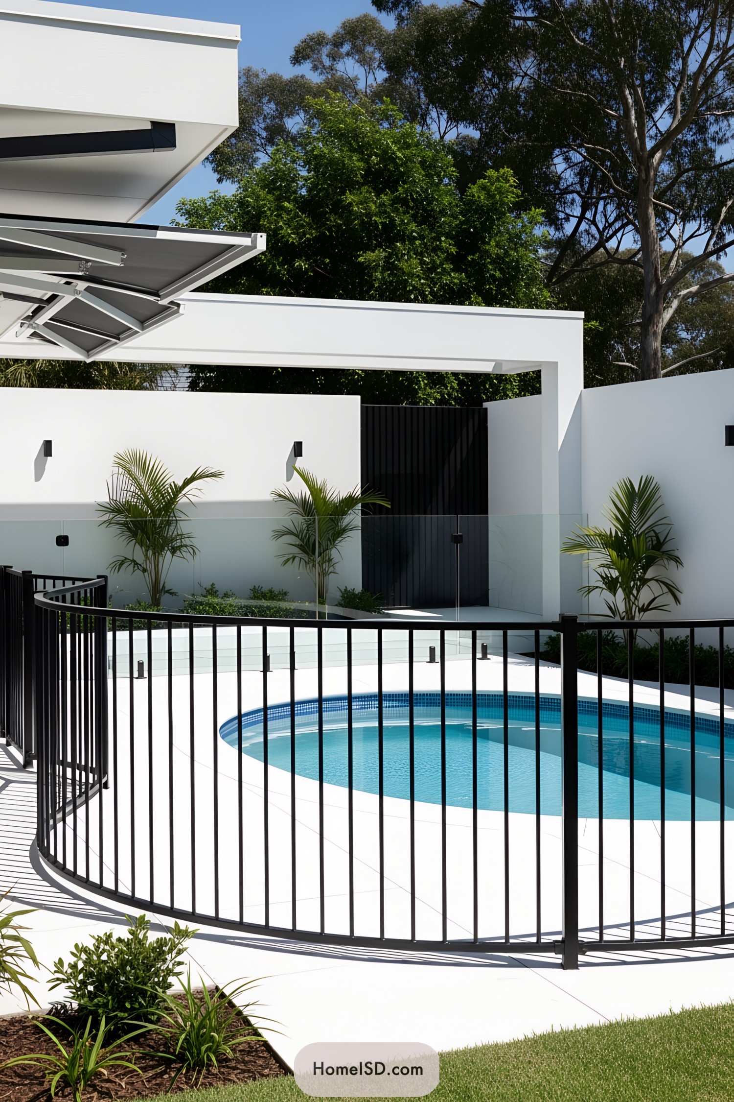 Round pool with a black metal fence and white surroundings