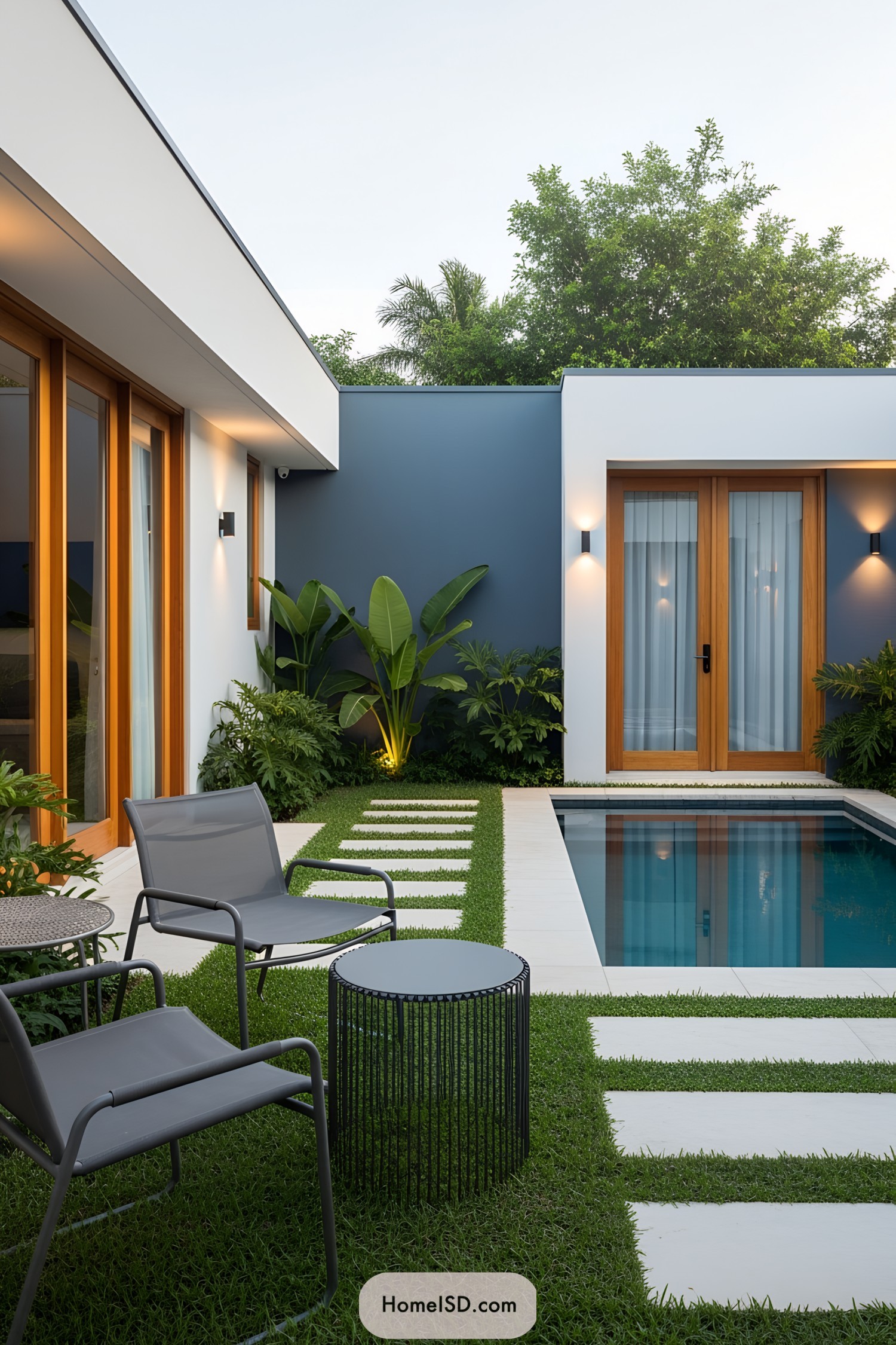 Small modern pool with grass and tile patio