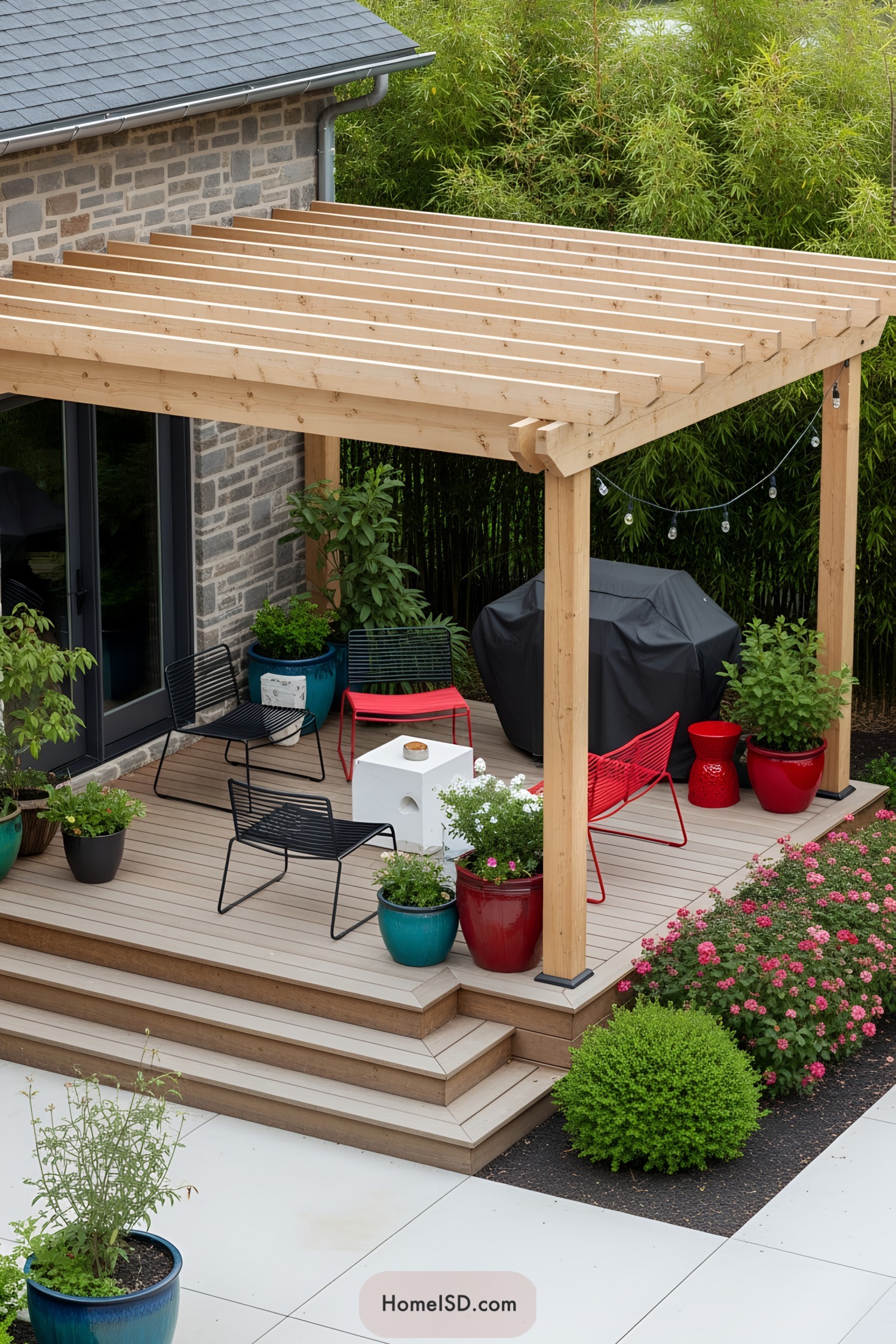 Wooden pergola over deck with colorful seating and plants