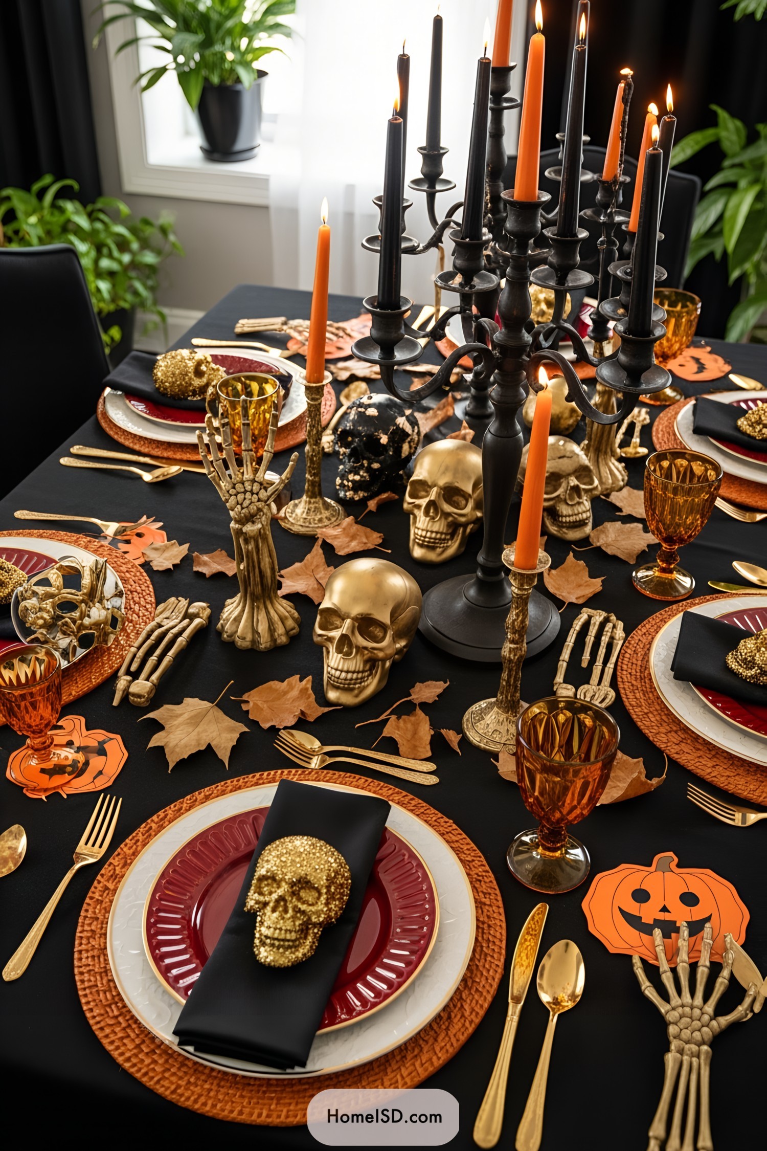 Halloween-themed dining table with skulls, candles, and autumn leaves
