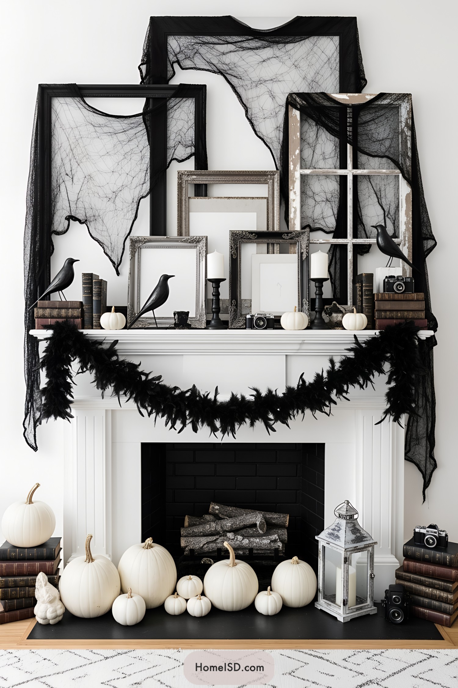 Chic mantel with Halloween decor, featuring frames, pumpkins, and ravens
