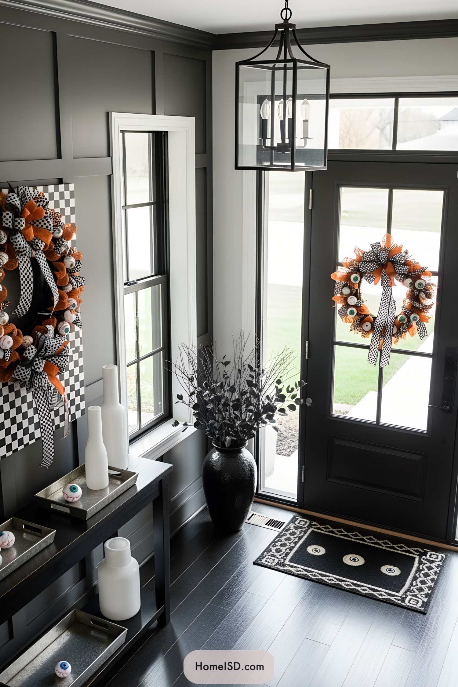 Halloween-themed wreaths with orange and black ribbons