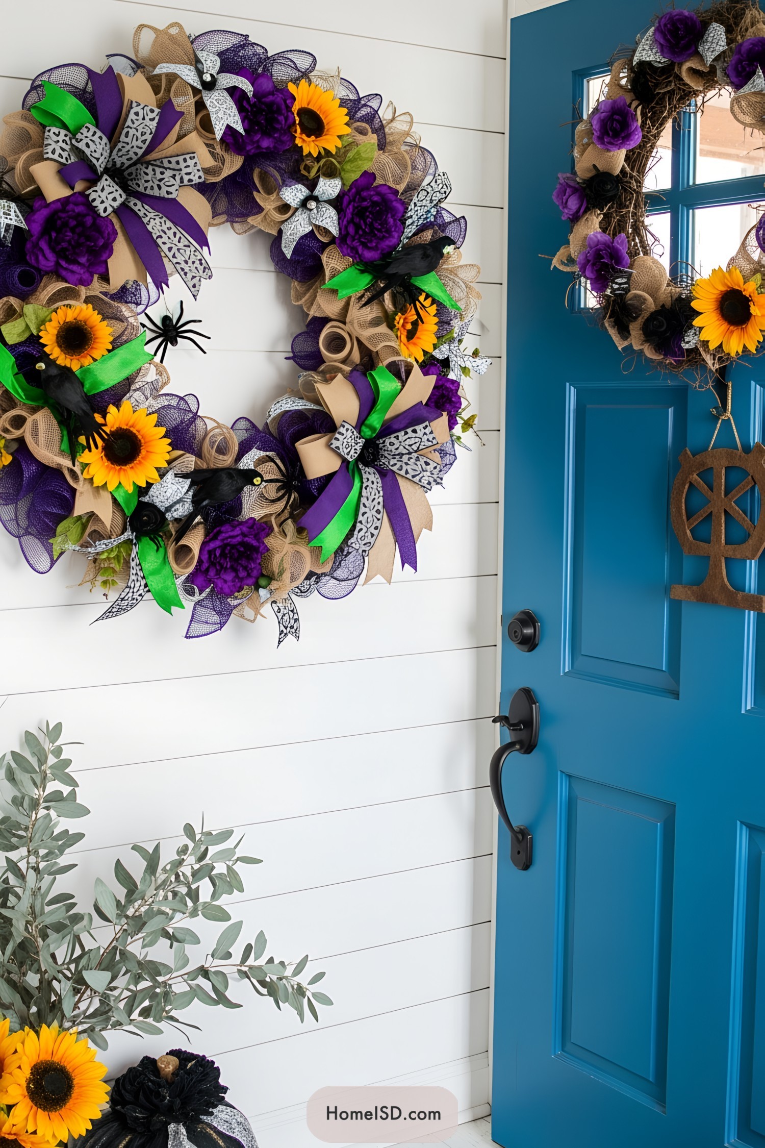 Bright and bold sunflower and purple wreath on blue door