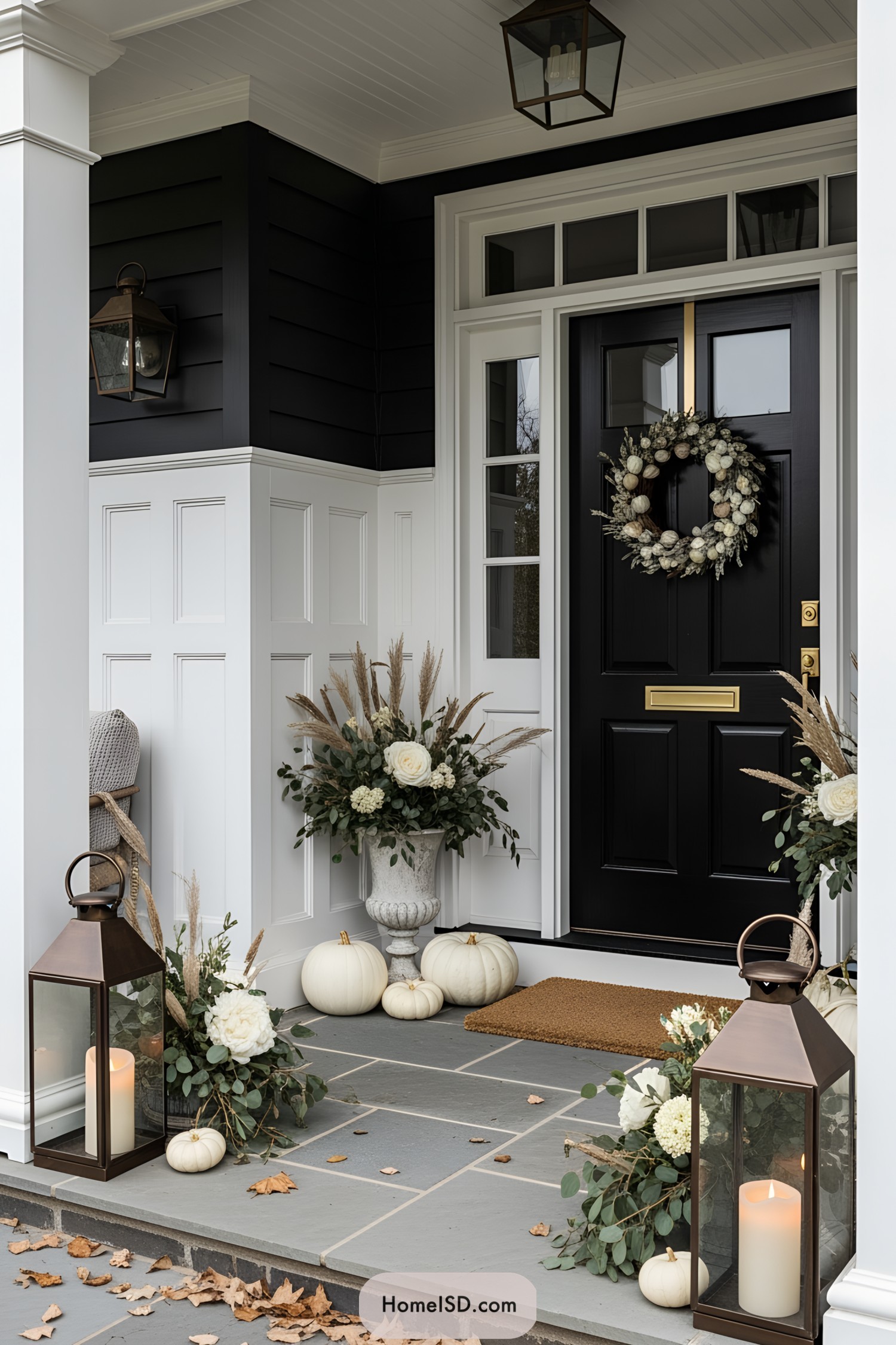 Autumn porch with white pumpkins, lanterns, and a wreath