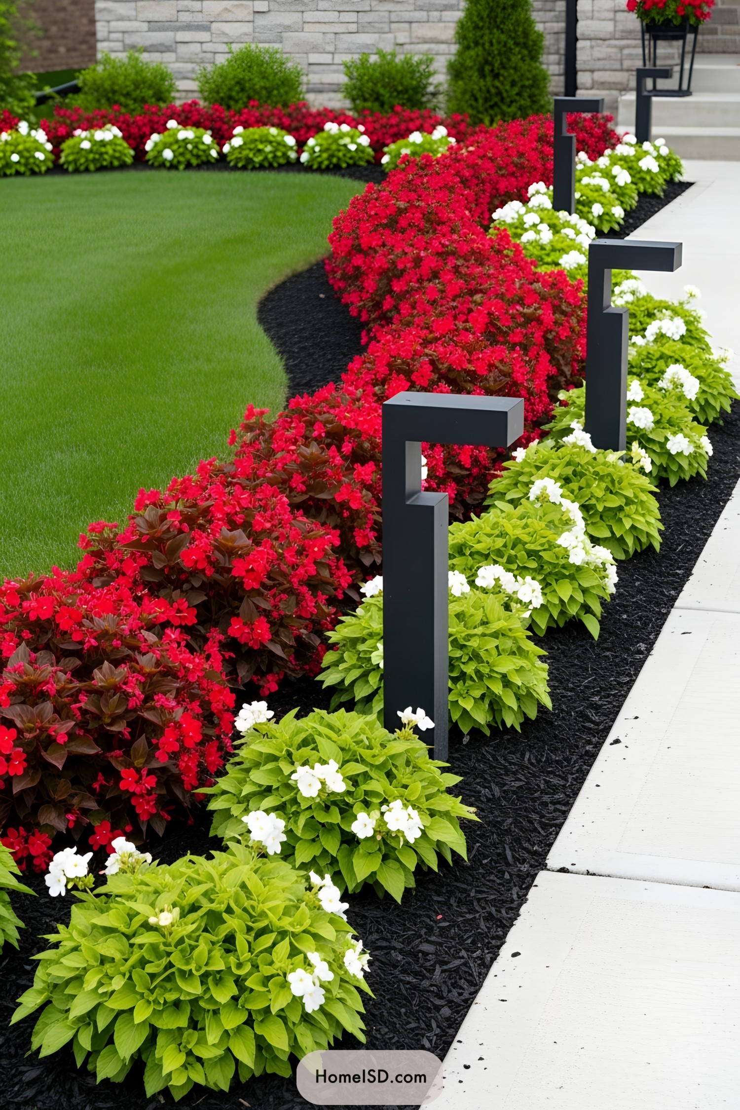 Front yard with vibrant red and white flowers along a walkway
