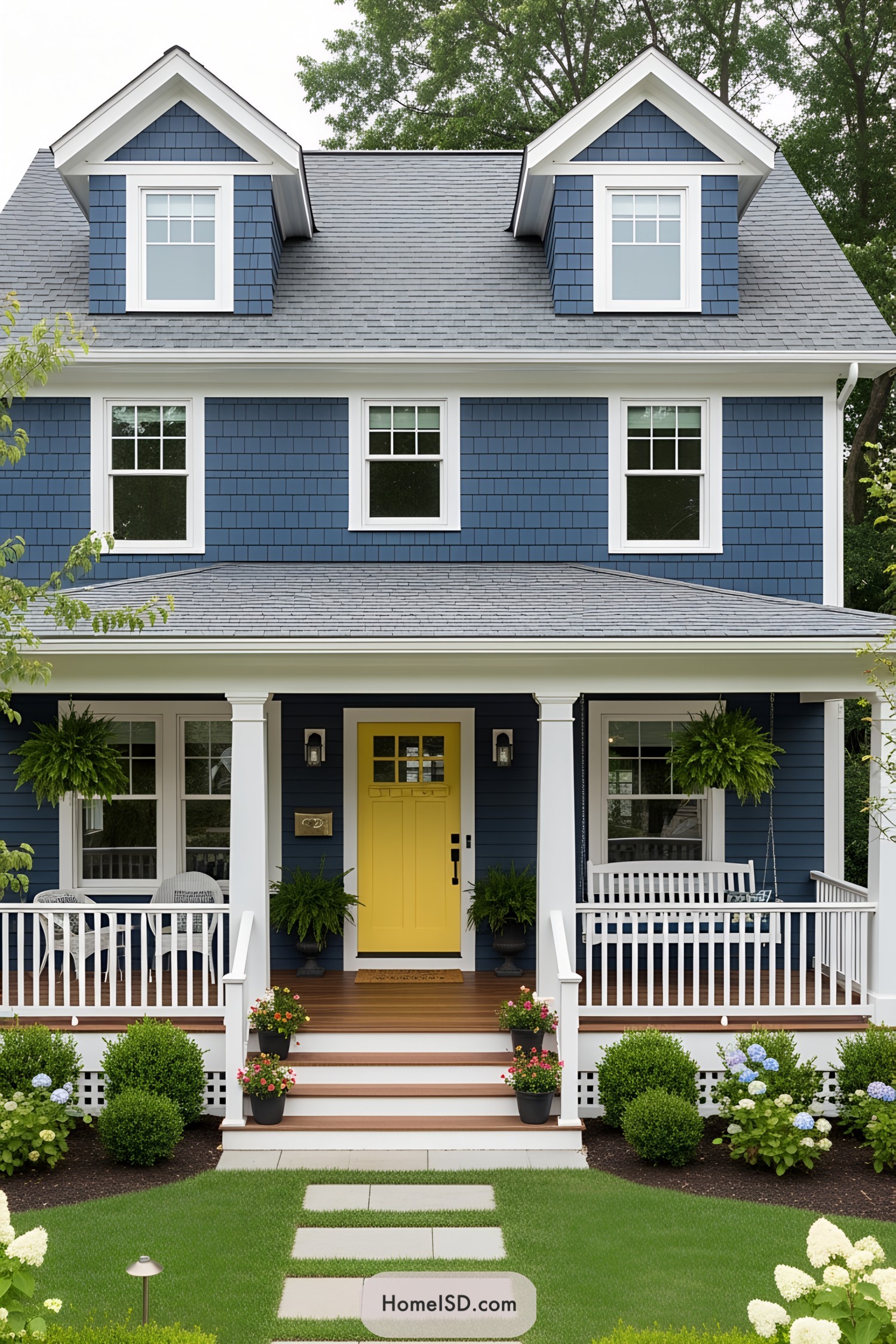 Bright yellow door on a navy blue house with a charming porch
