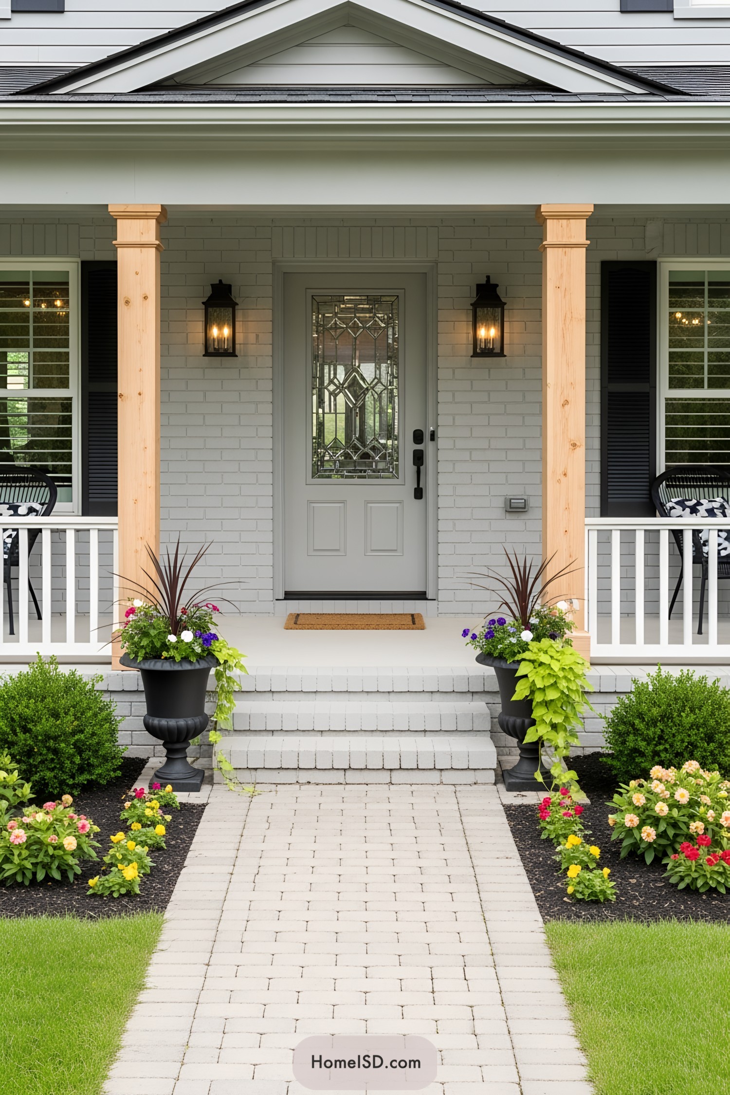 Front porch with potted plants and brick pathway