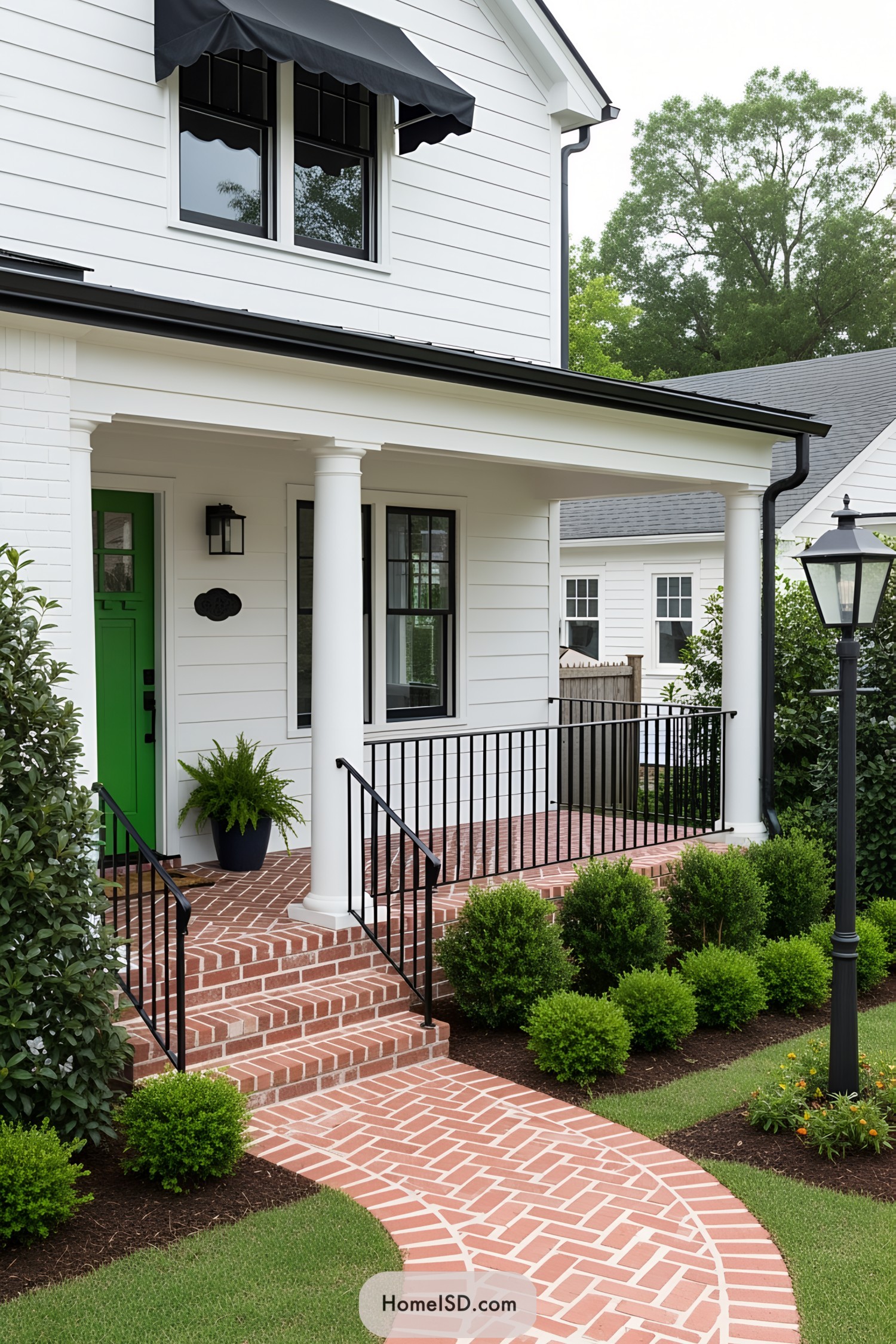 Classic porch with black awning and green door