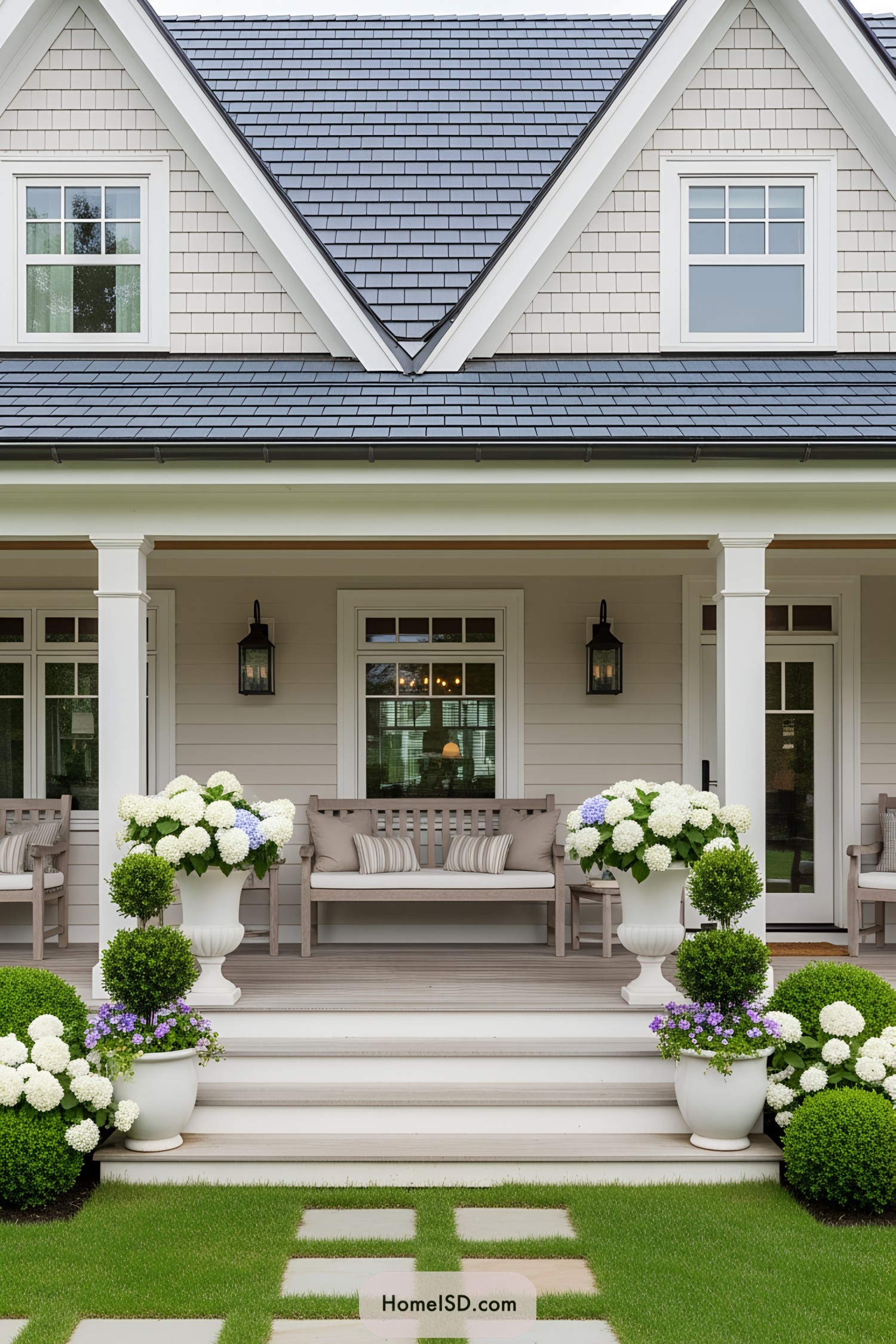 Inviting front porch with benches and lush plants