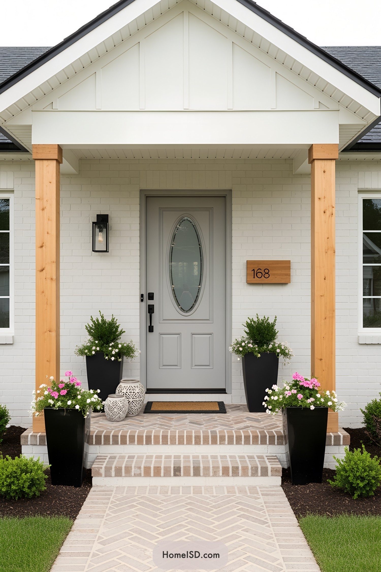 Stylish porch with potted plants and light gray door