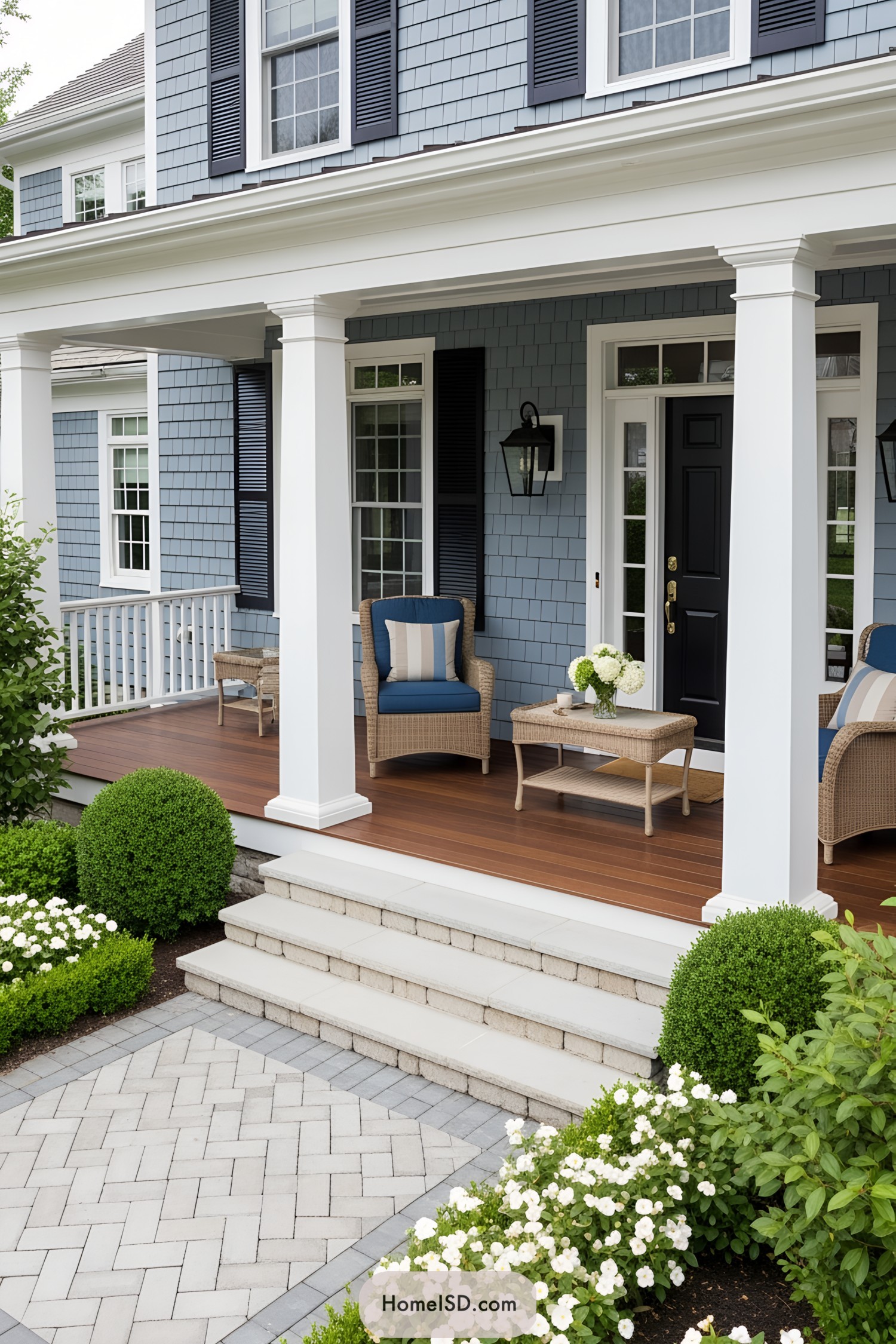A chic front porch with blue siding and inviting wicker furniture