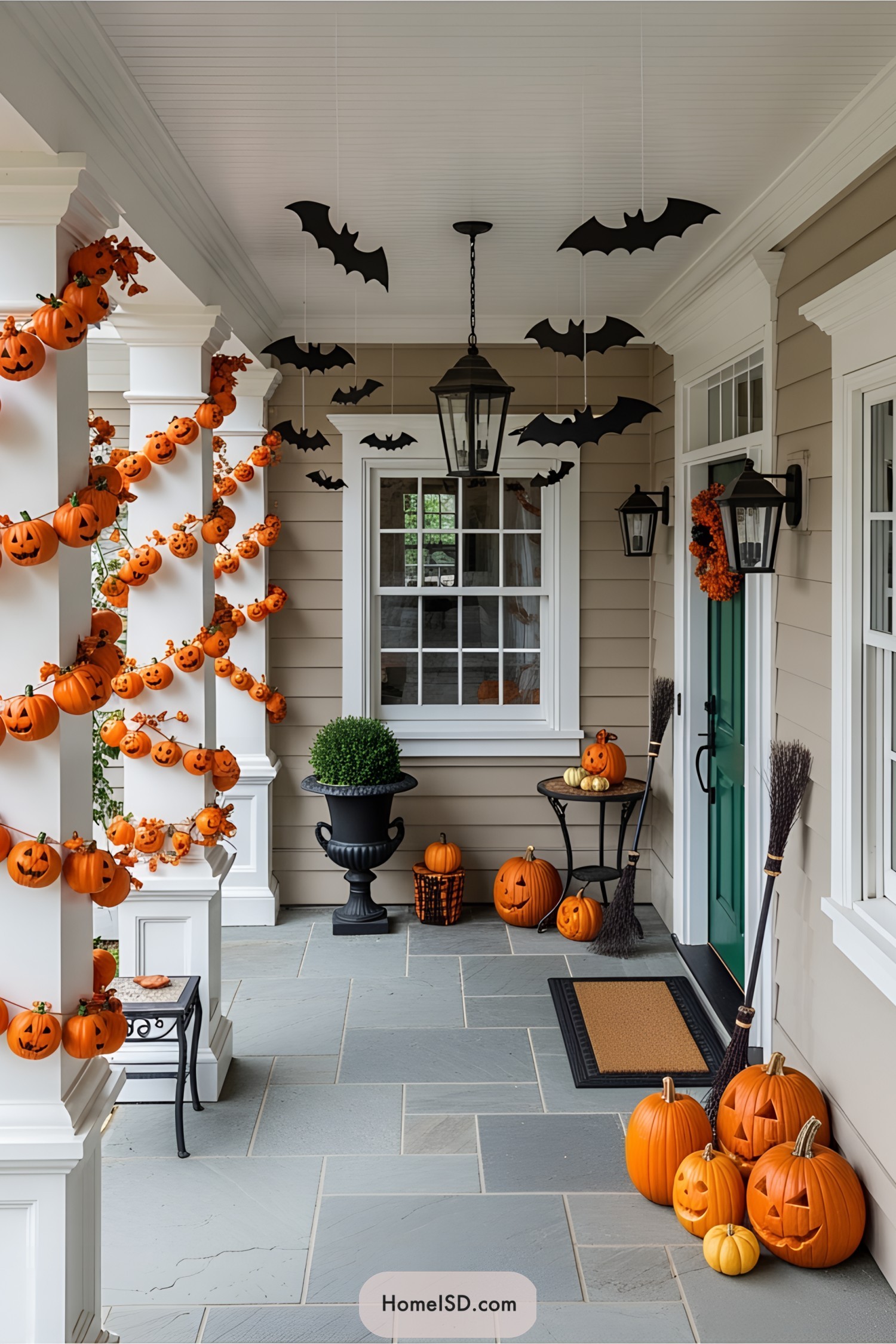 Porch with pumpkins, bats, and brooms