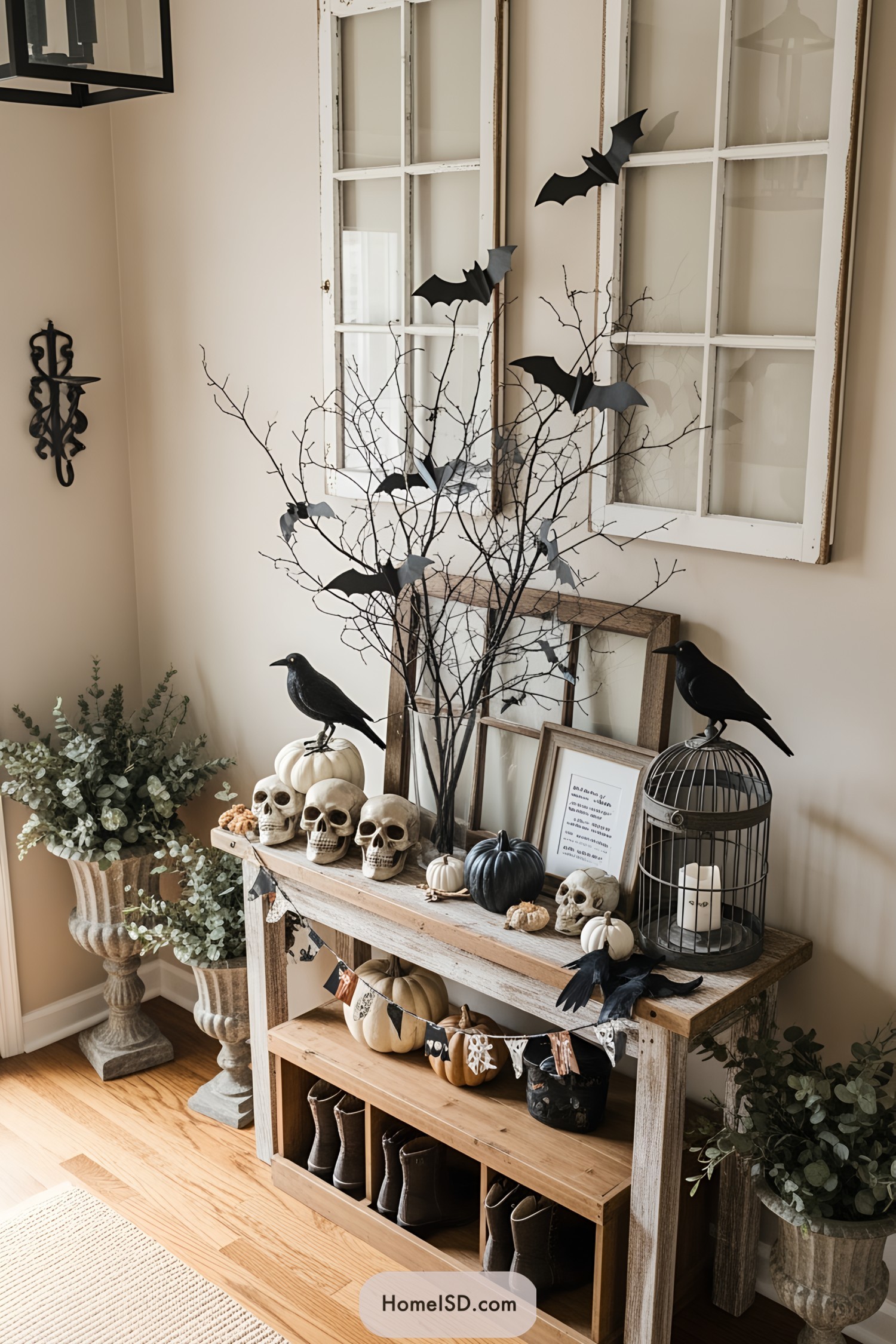 Halloween-themed entryway decor with bats, skulls, and pumpkins