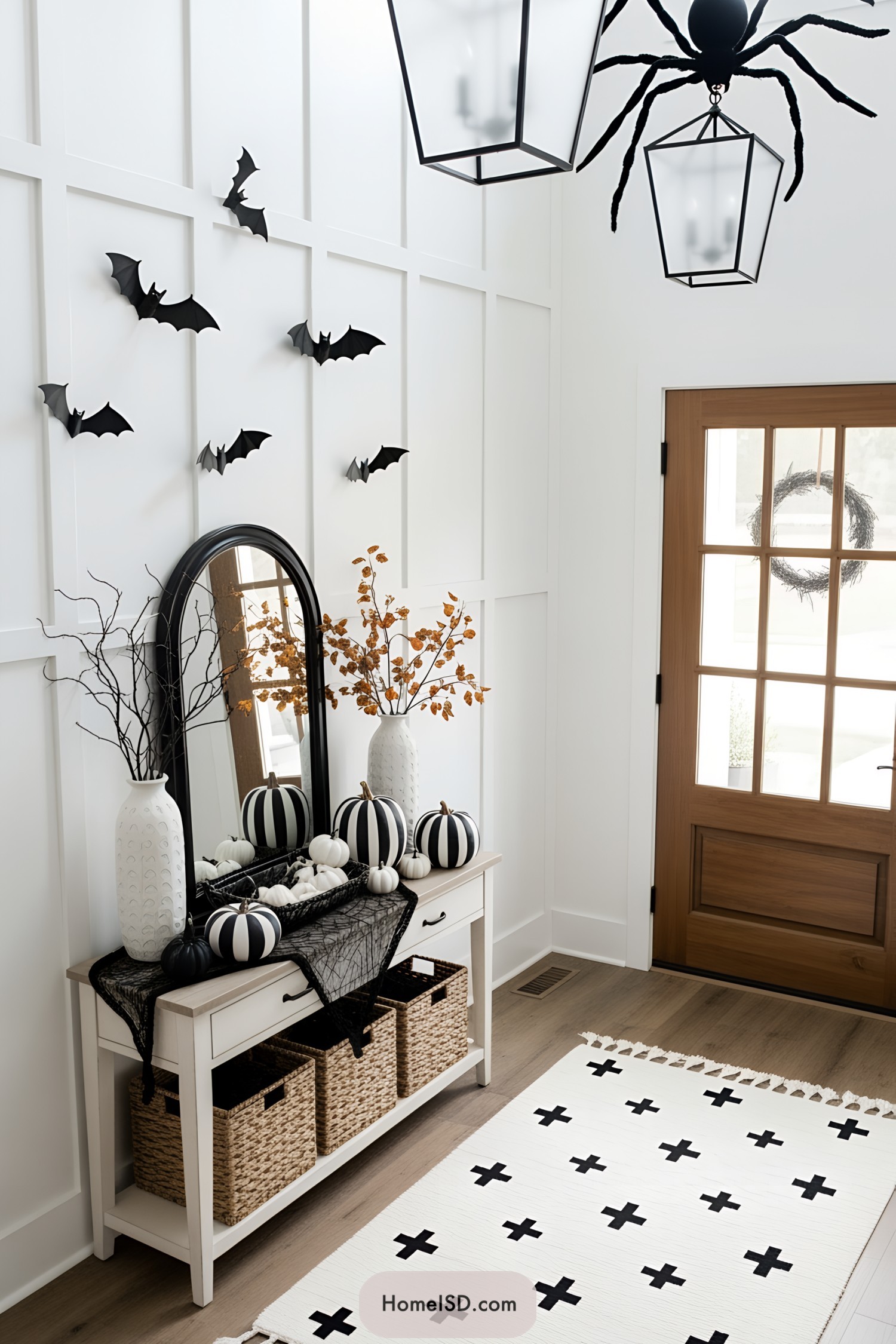 Halloween-themed entryway with bats, pumpkins, and a giant spider