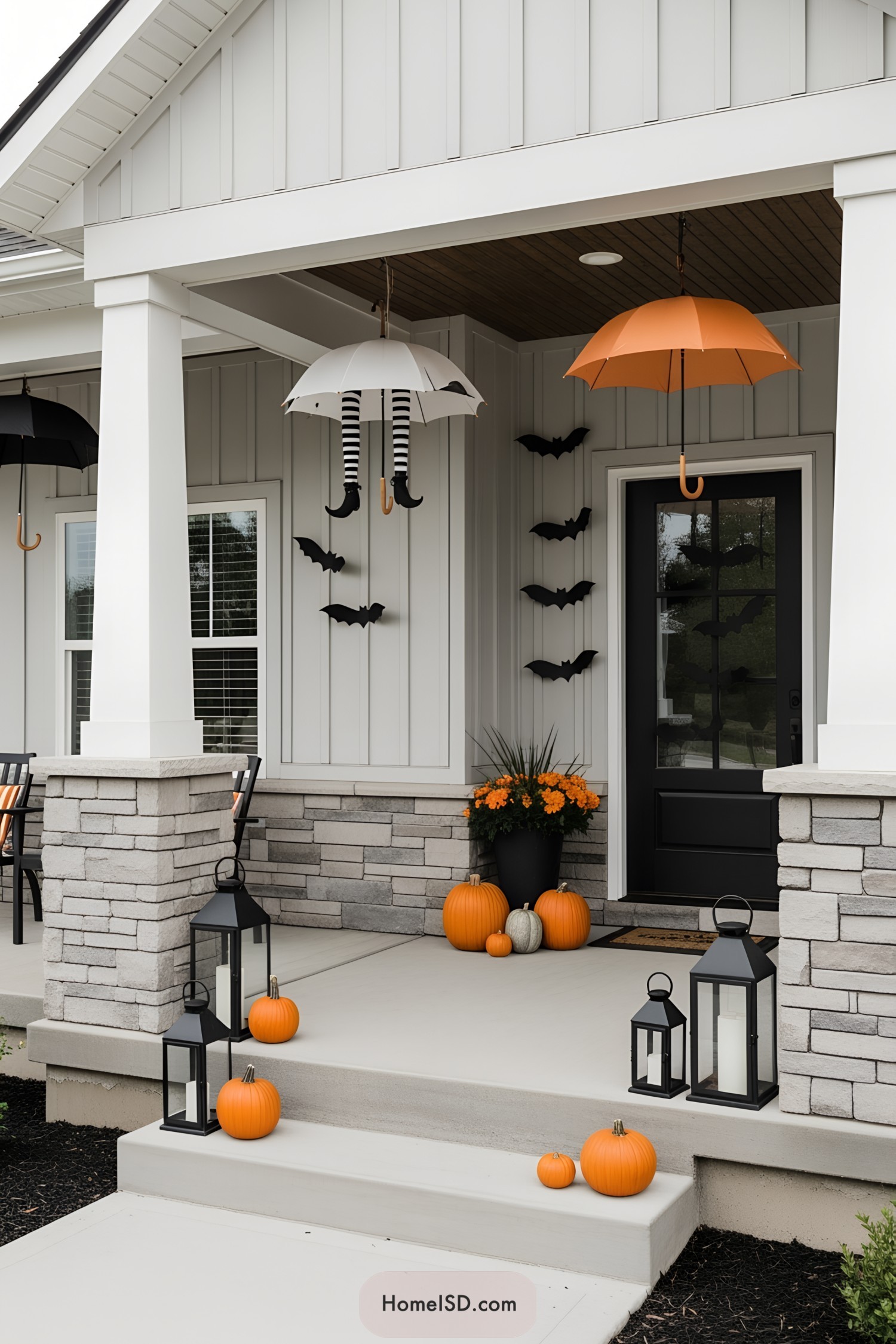 Halloween-themed porch with bats, umbrellas, and pumpkins