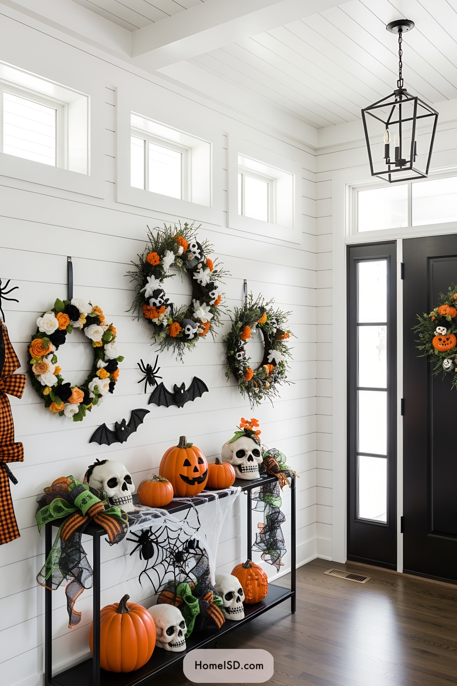 Halloween-themed entryway with wreaths and pumpkin decor