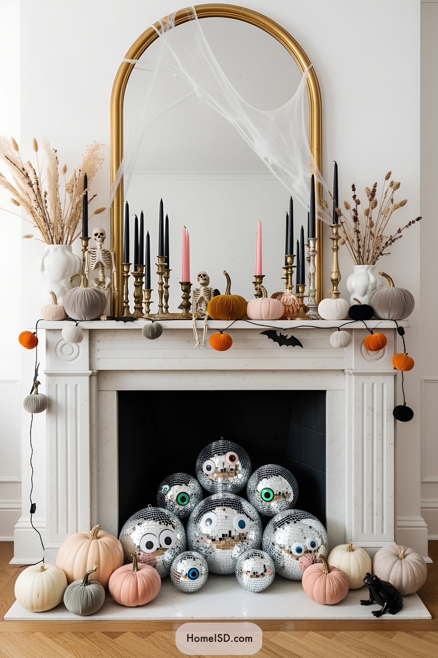 Halloween-themed mantle with skeletons, pumpkins, and disco balls