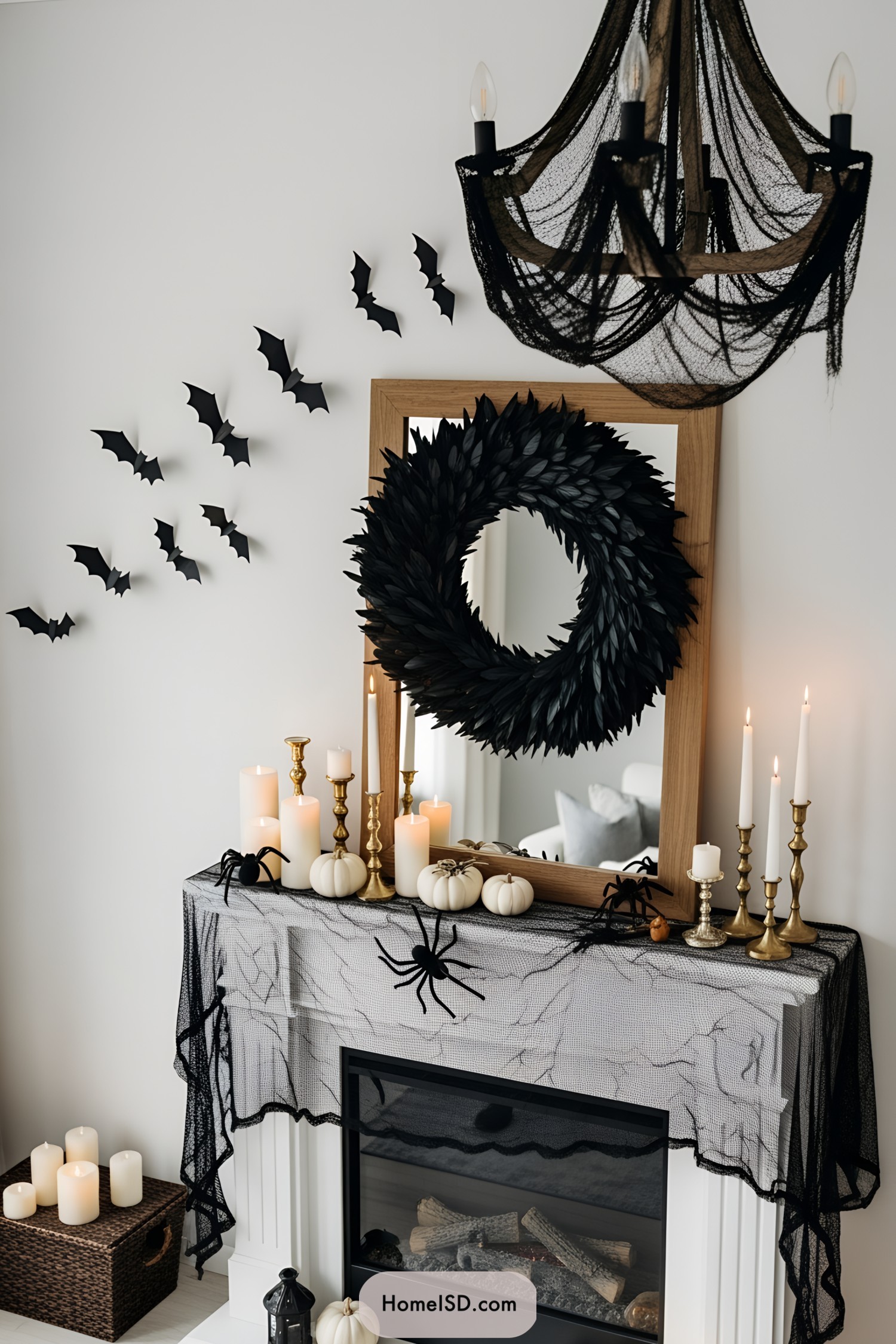 Halloween-themed mantle with black wreath, bats, and candles