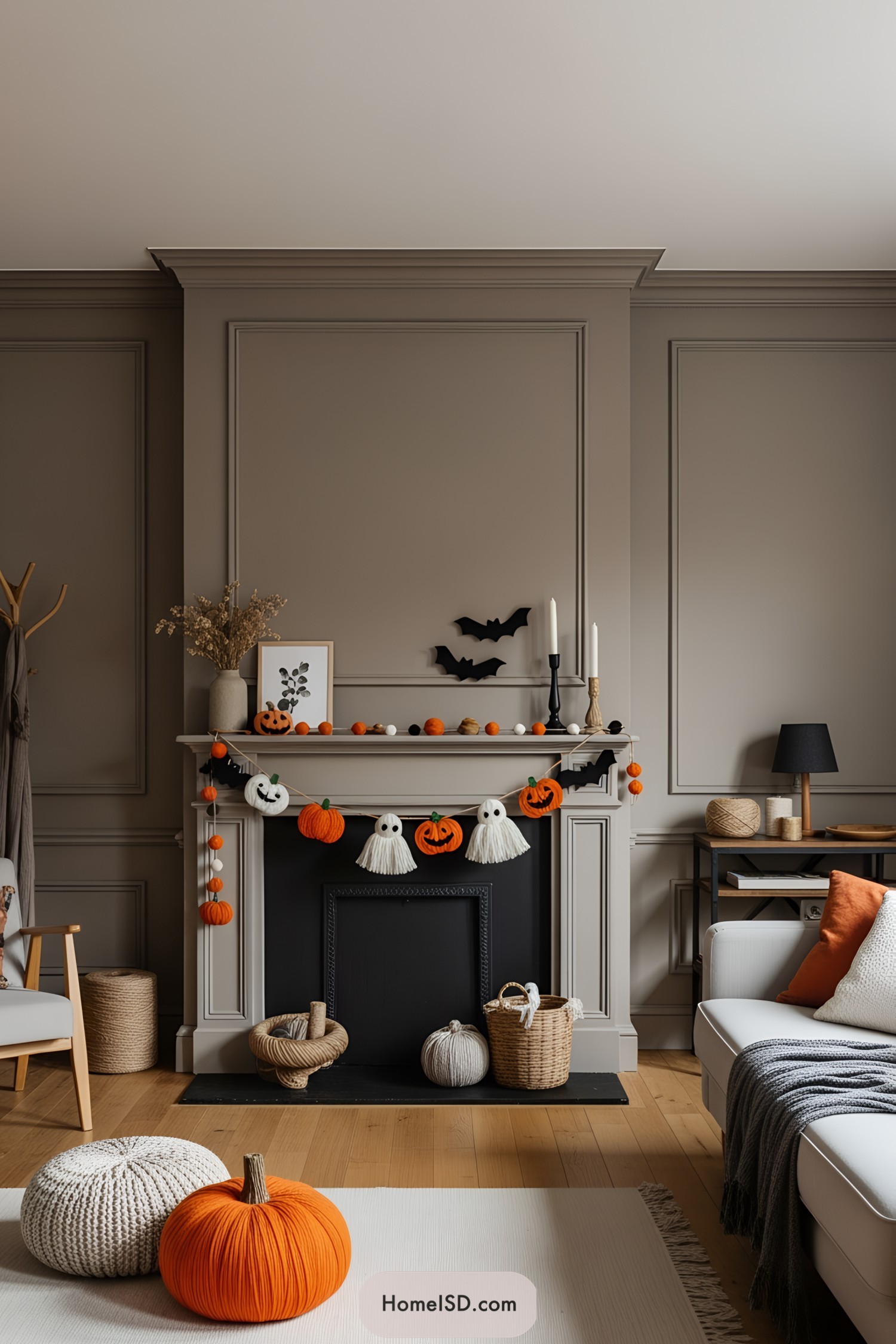 Halloween-themed mantel with knitted pumpkins and ghost decorations