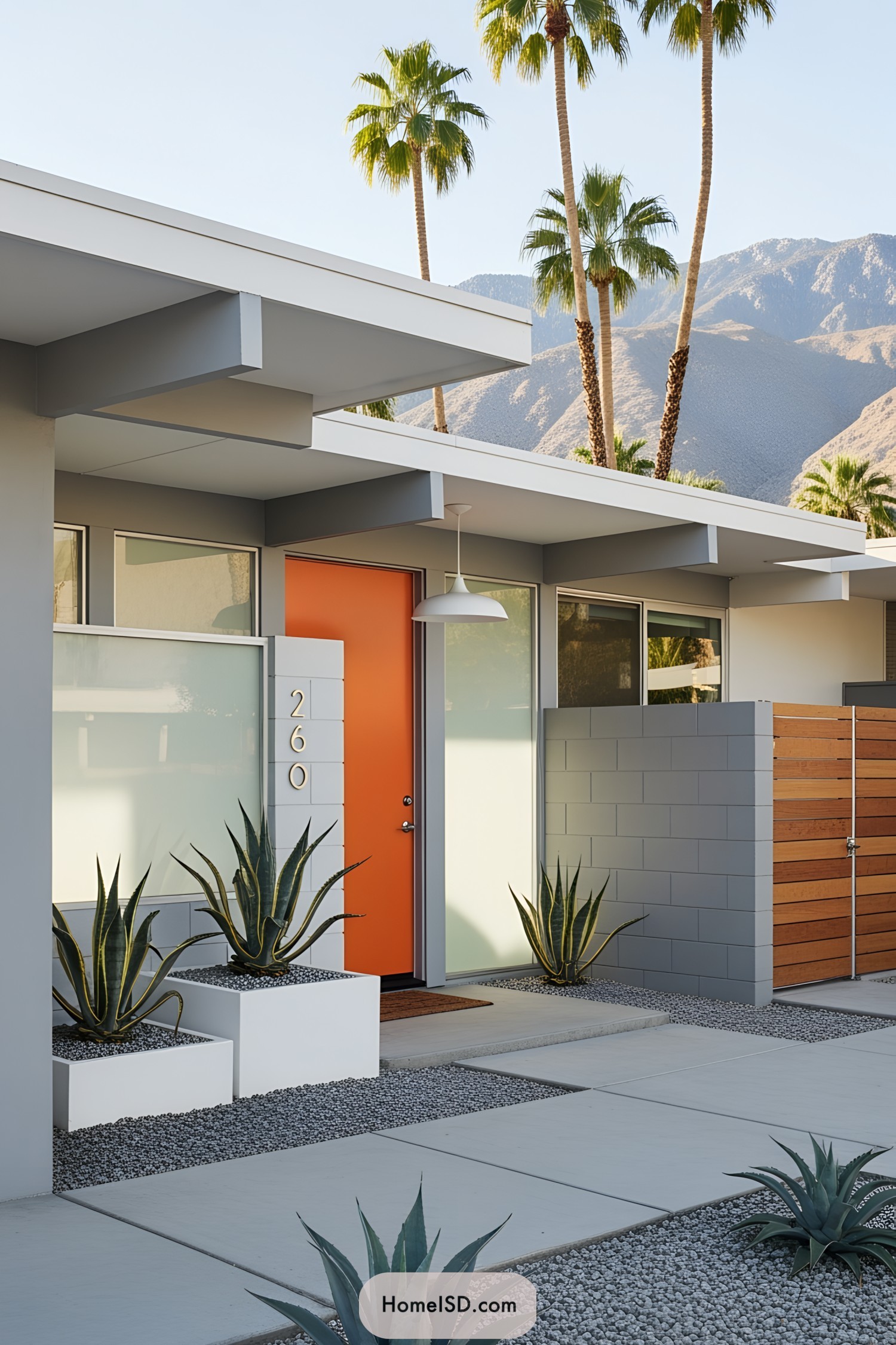 Modern home exterior with orange door and desert landscaping