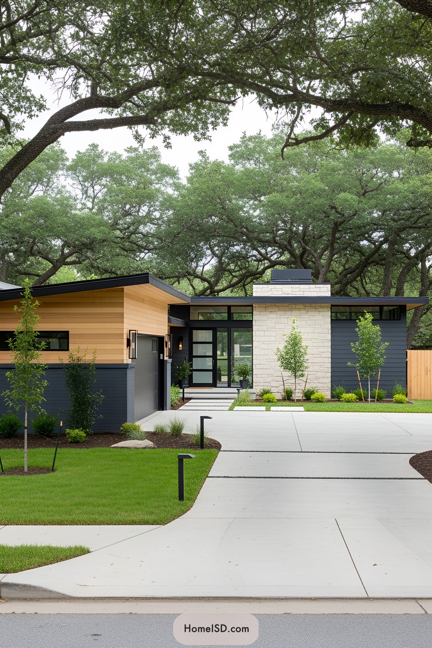 Sleek modern house with lush lawn and winding driveway