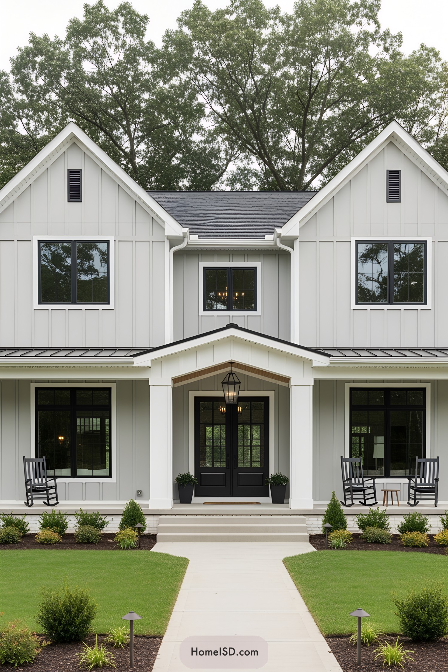 Modern front porch with black rocking chairs and lush green lawn