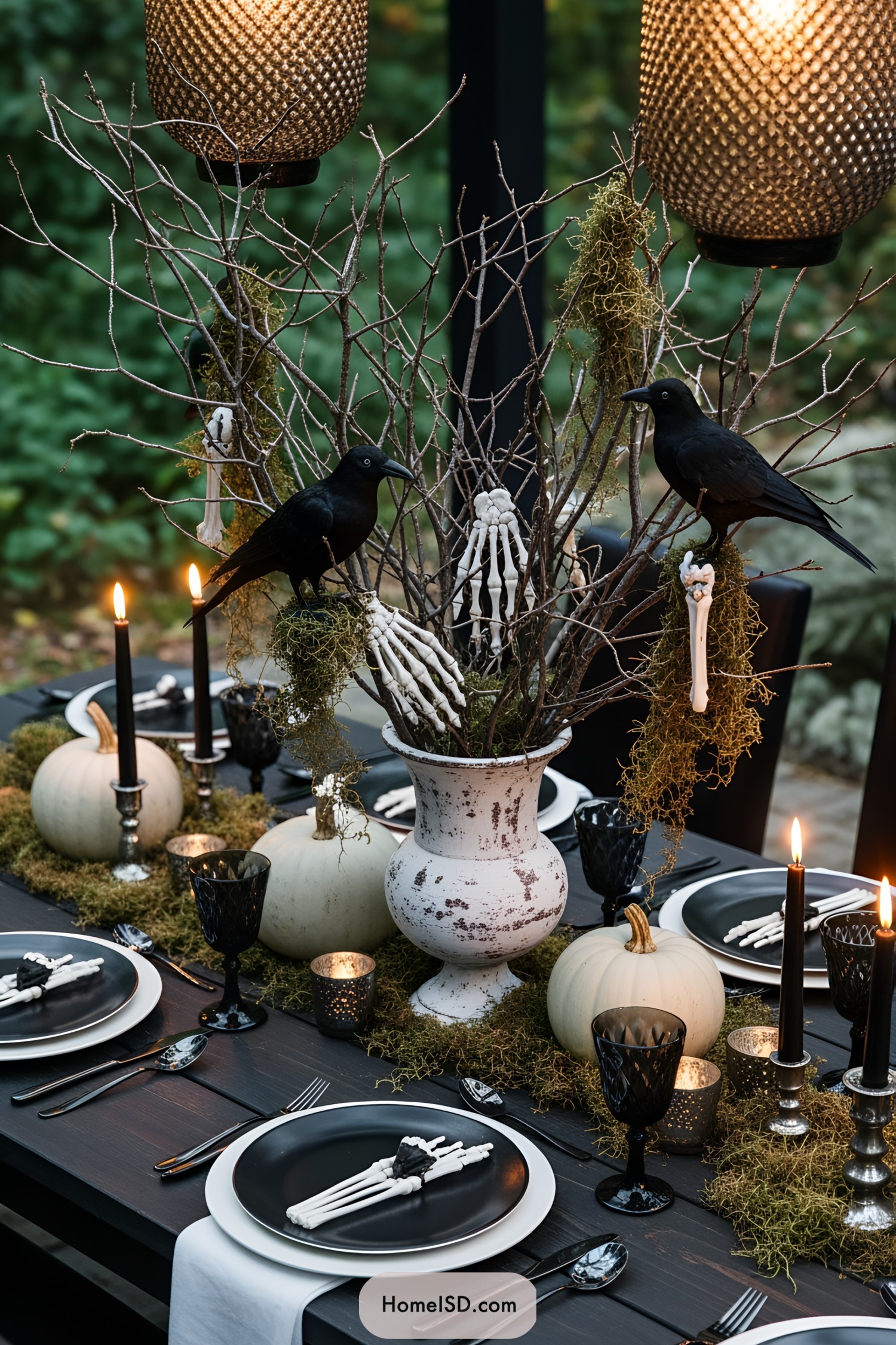 Halloween-themed table with crows, pumpkins, and skeletal decor