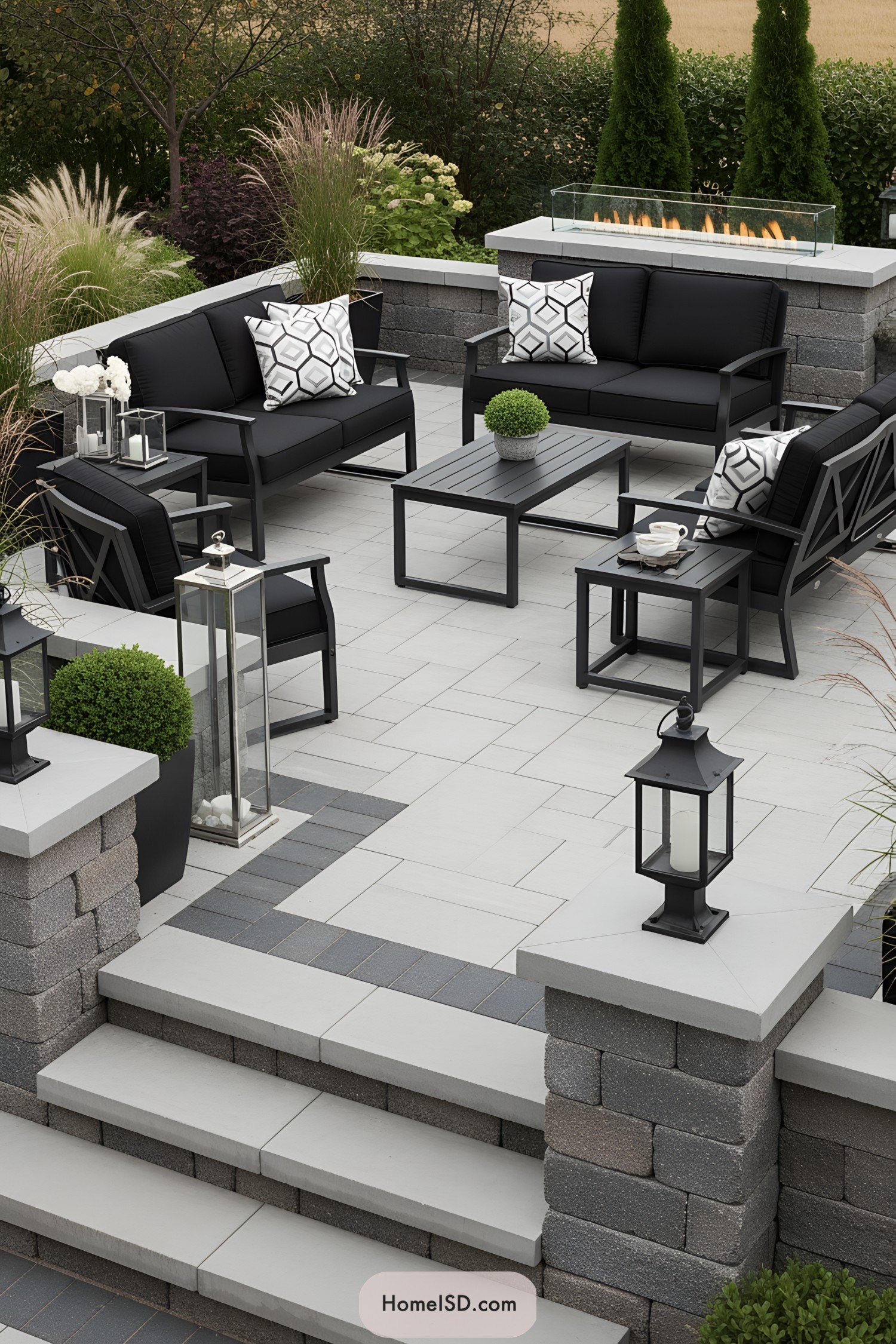 Contemporary outdoor patio with black seating and a sleek fire feature