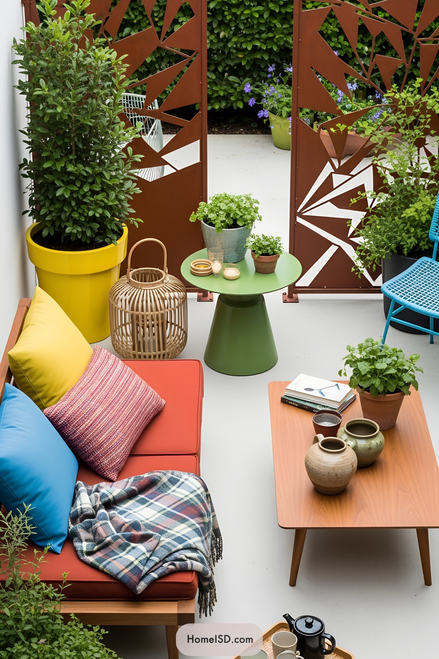Colorful small patio with potted plants, cozy seating, and eclectic decor