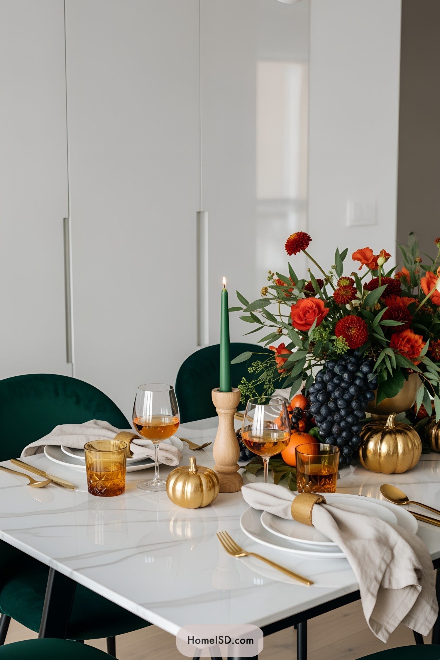 Elegant table setting with flowers, pumpkins, and candles