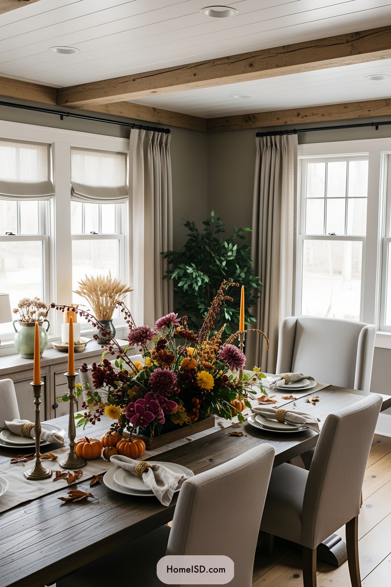 Autumn-themed centerpiece with vibrant flowers and pumpkins