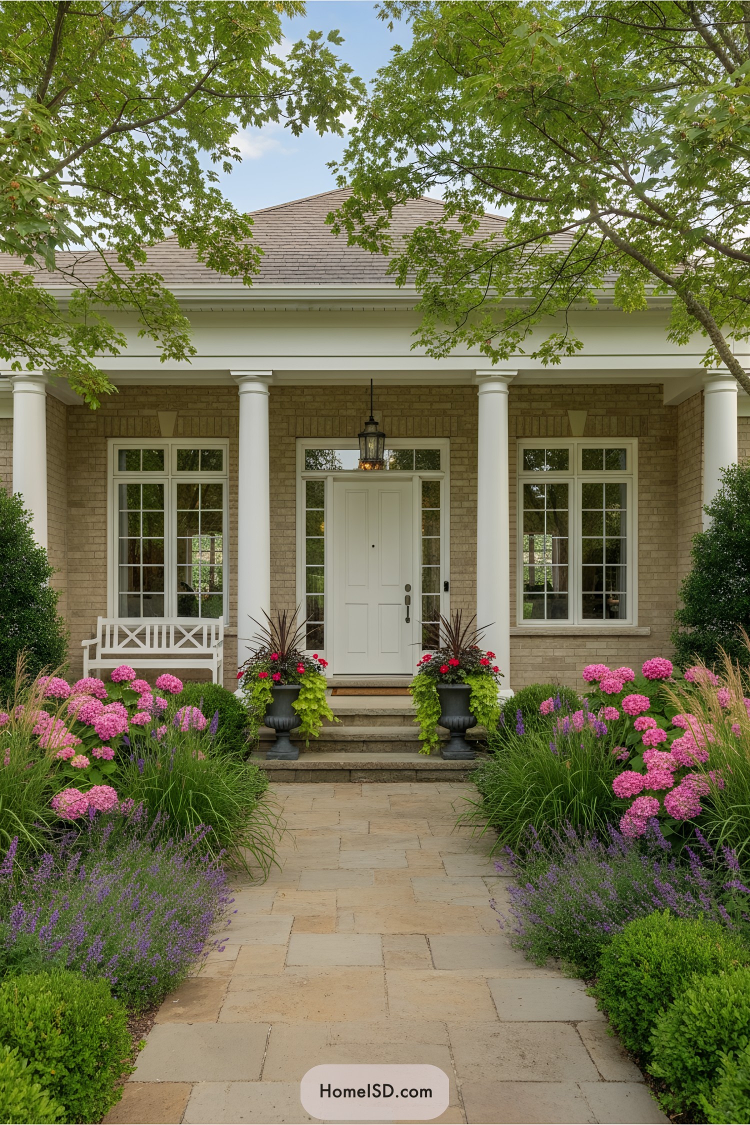 Front porch with blooming flowers and columns