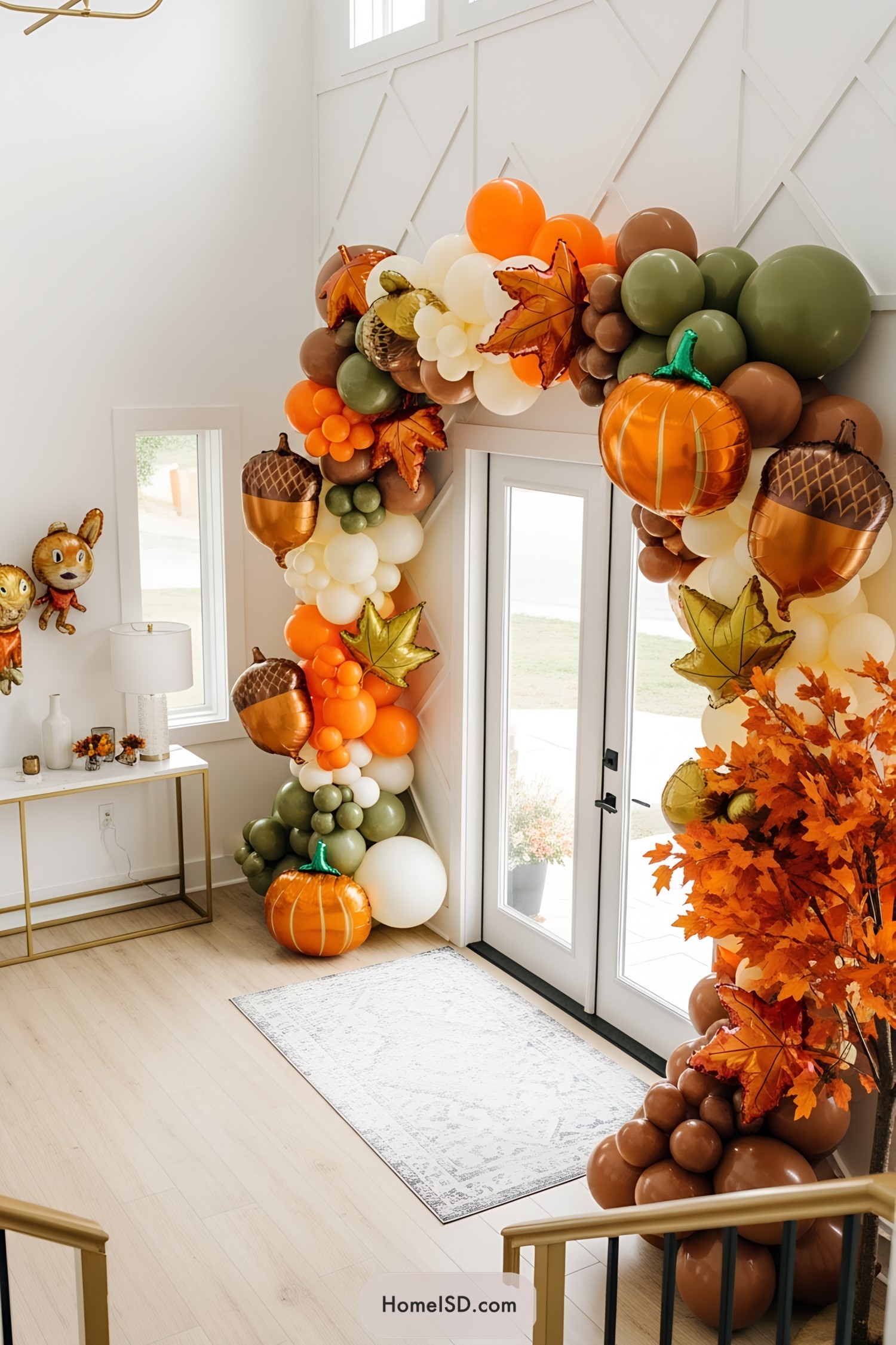 Colorful Thanksgiving balloon arch with pumpkins and leaves