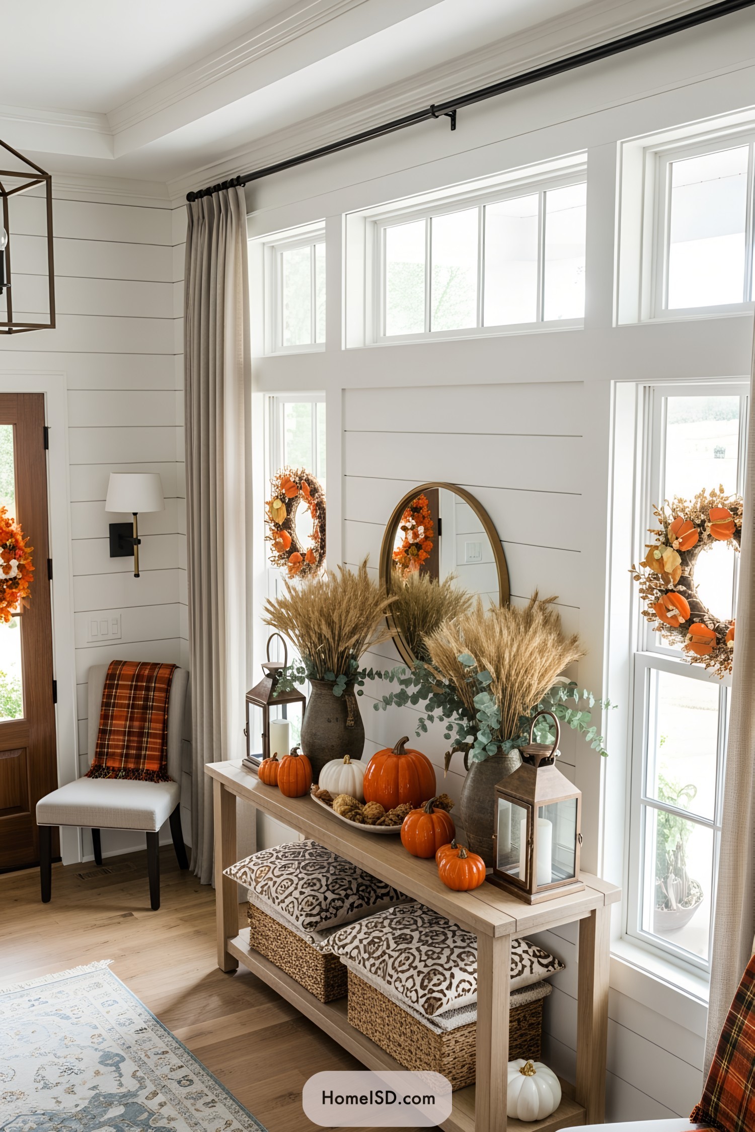 Entryway decorated with Thanksgiving wreaths, pumpkins, and cozy accents