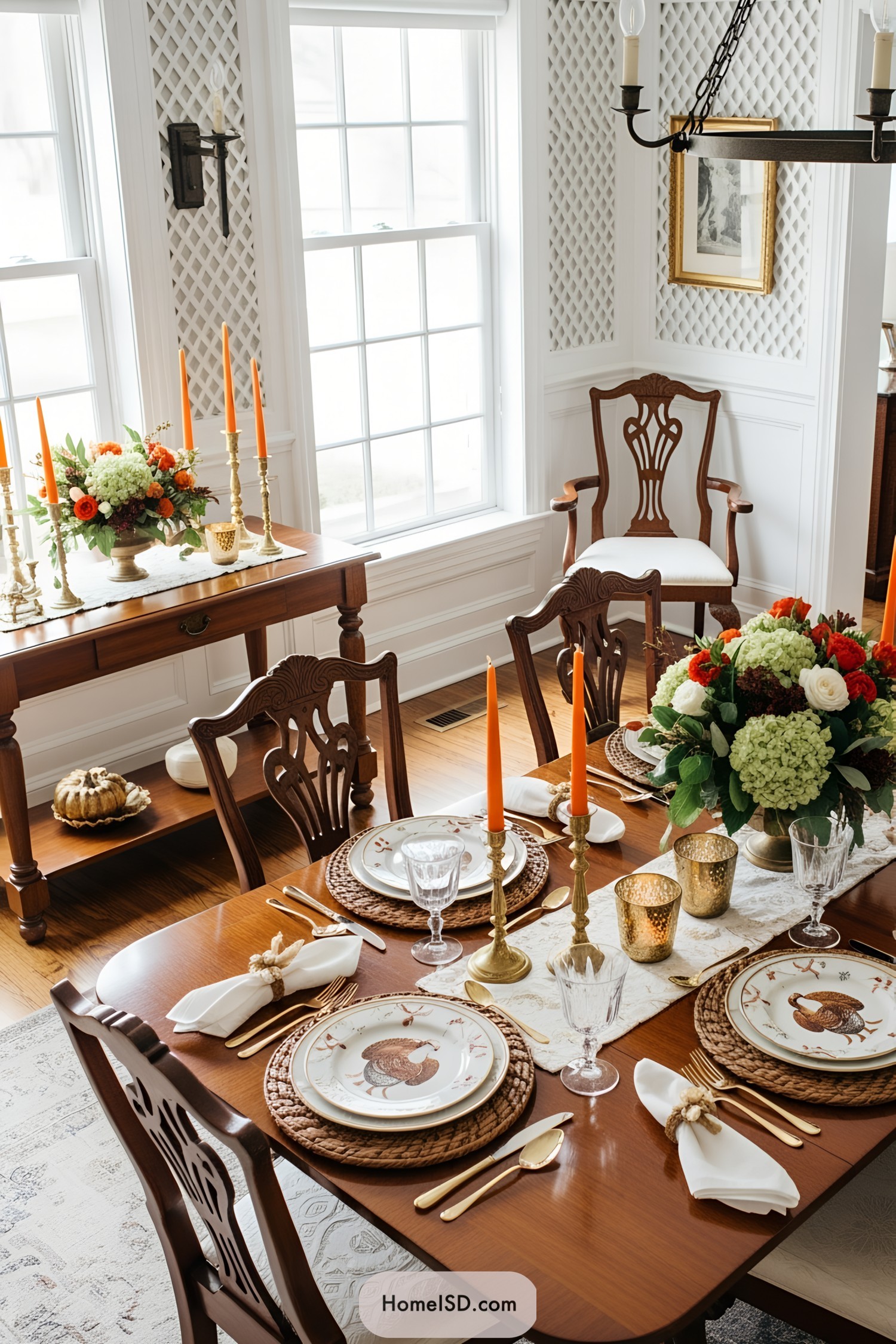 Elegant dining table set for Thanksgiving with orange candles