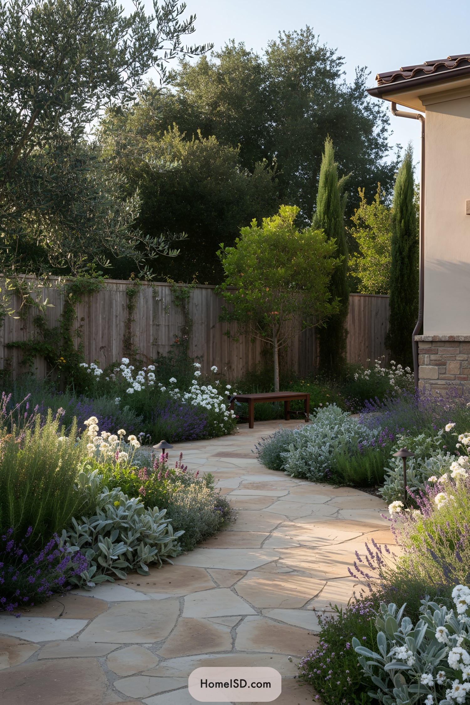 Sunlit stone pathway surrounded by lush Mediterranean plants