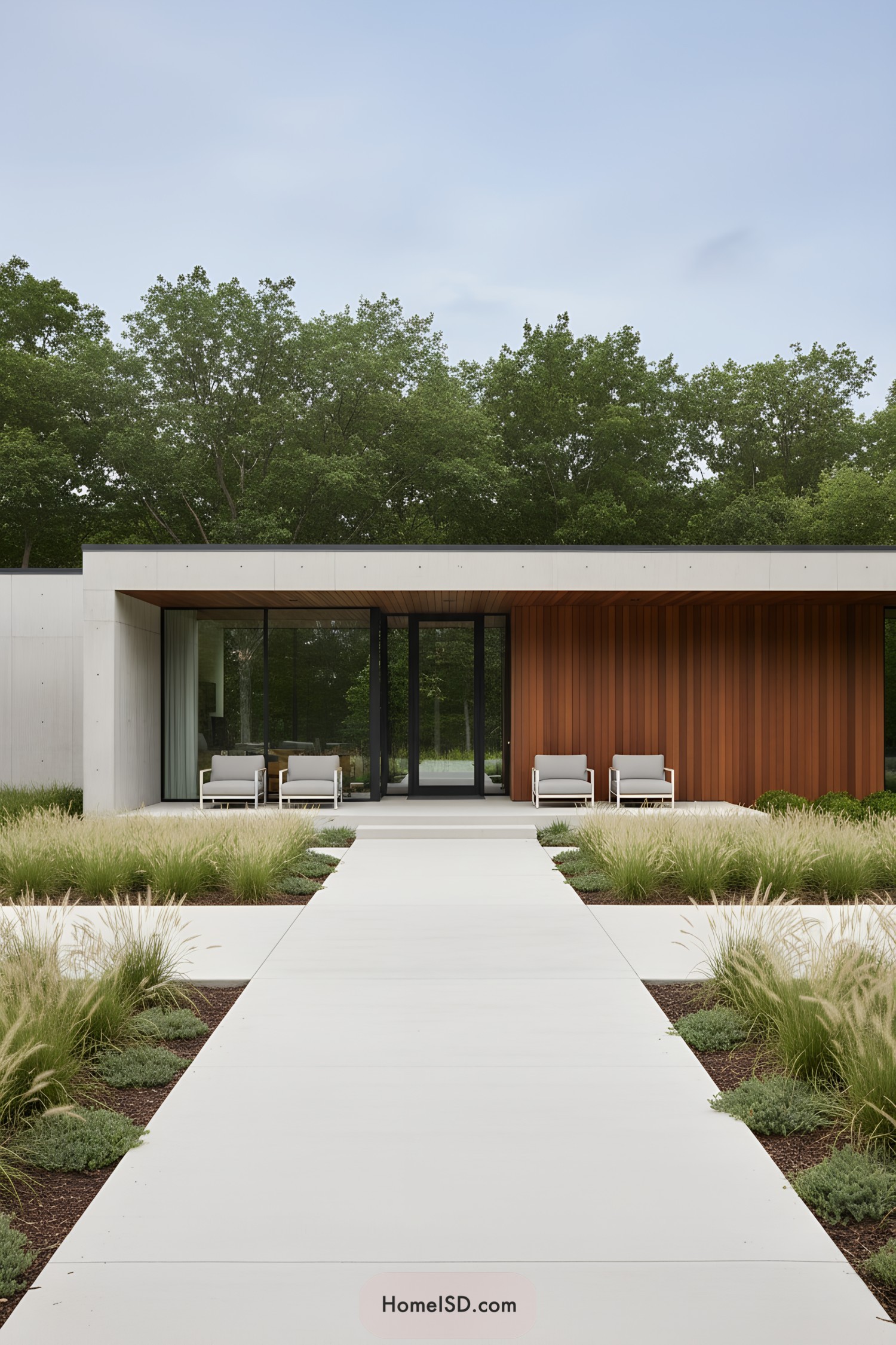 Contemporary home entrance with sleek patio chairs and minimalist landscaping