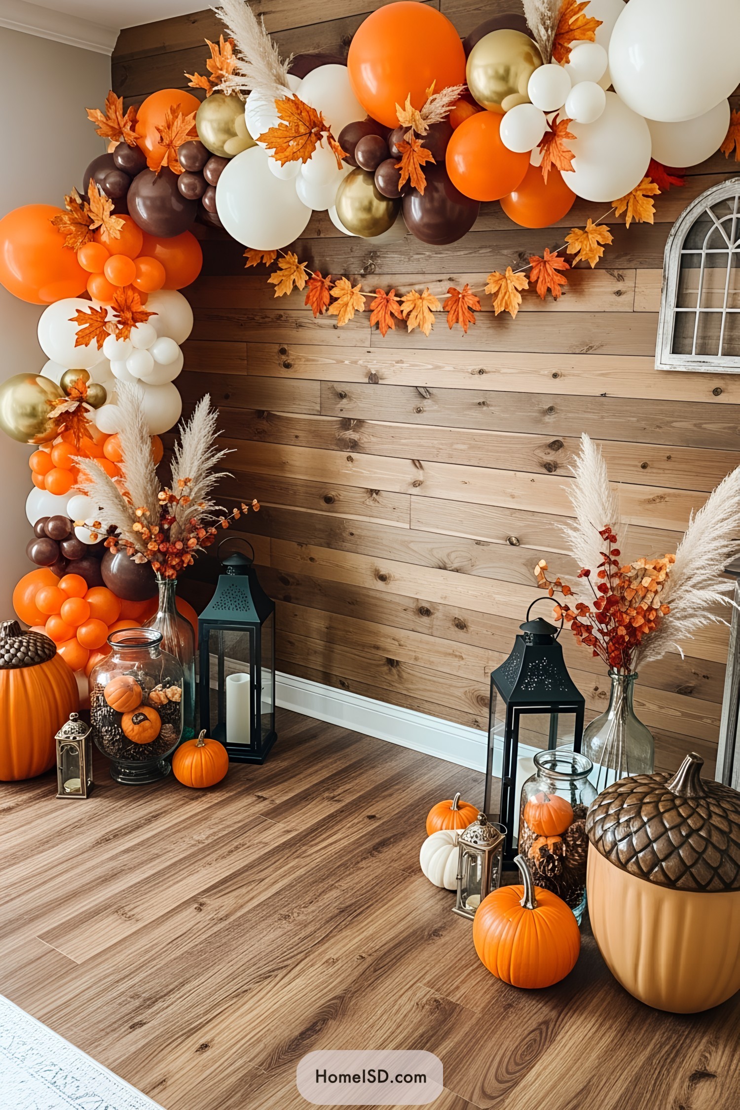 Festive autumn balloons and pumpkins by a wooden wall