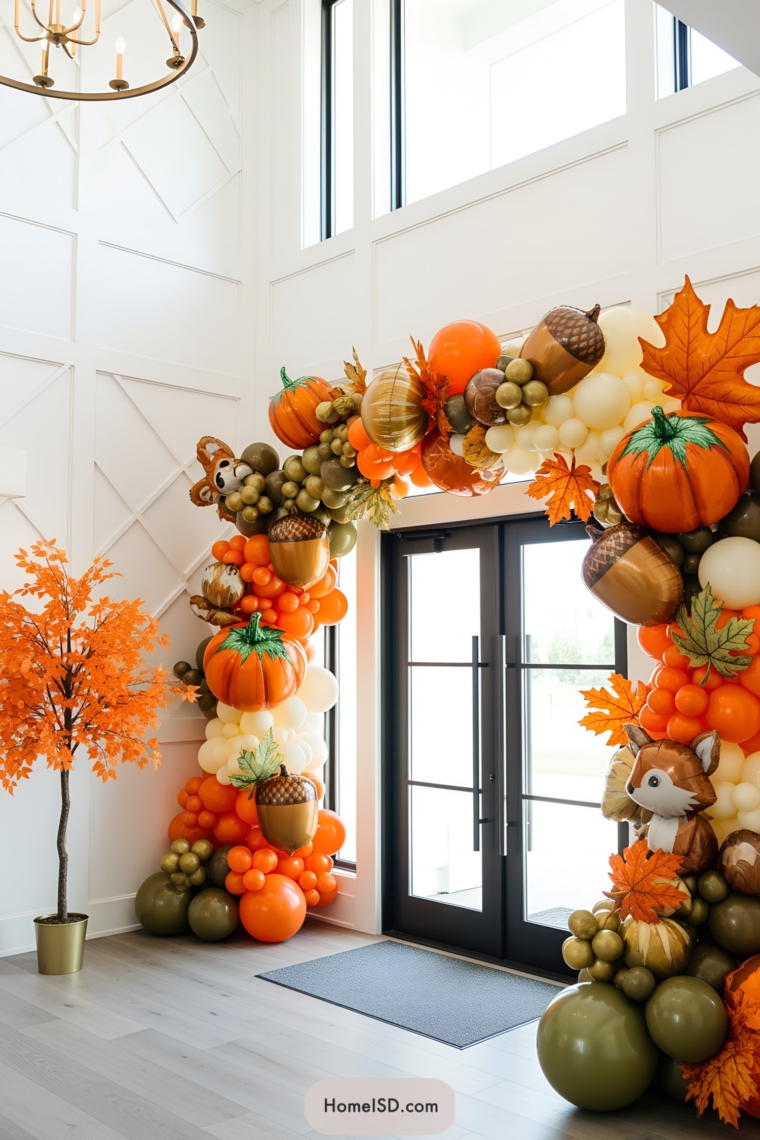 Colorful balloon arch with pumpkins and leaf accents