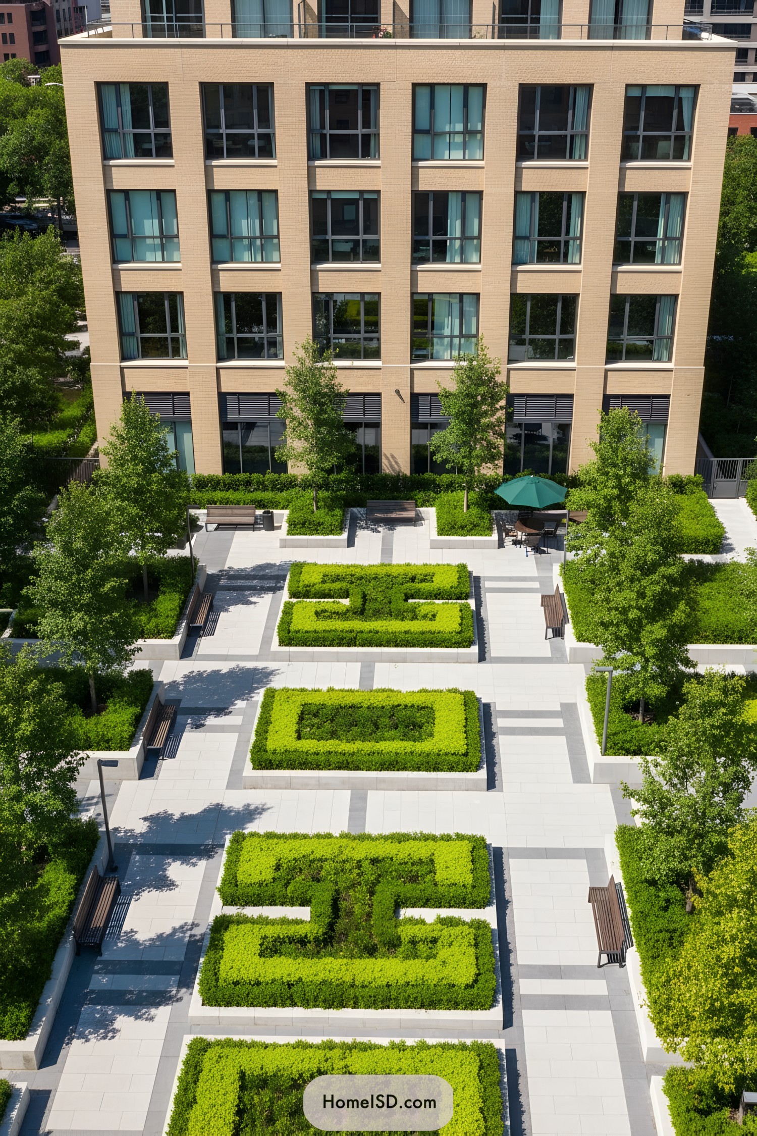 Elevated view of a neatly arranged, green landscape with pathways and a building