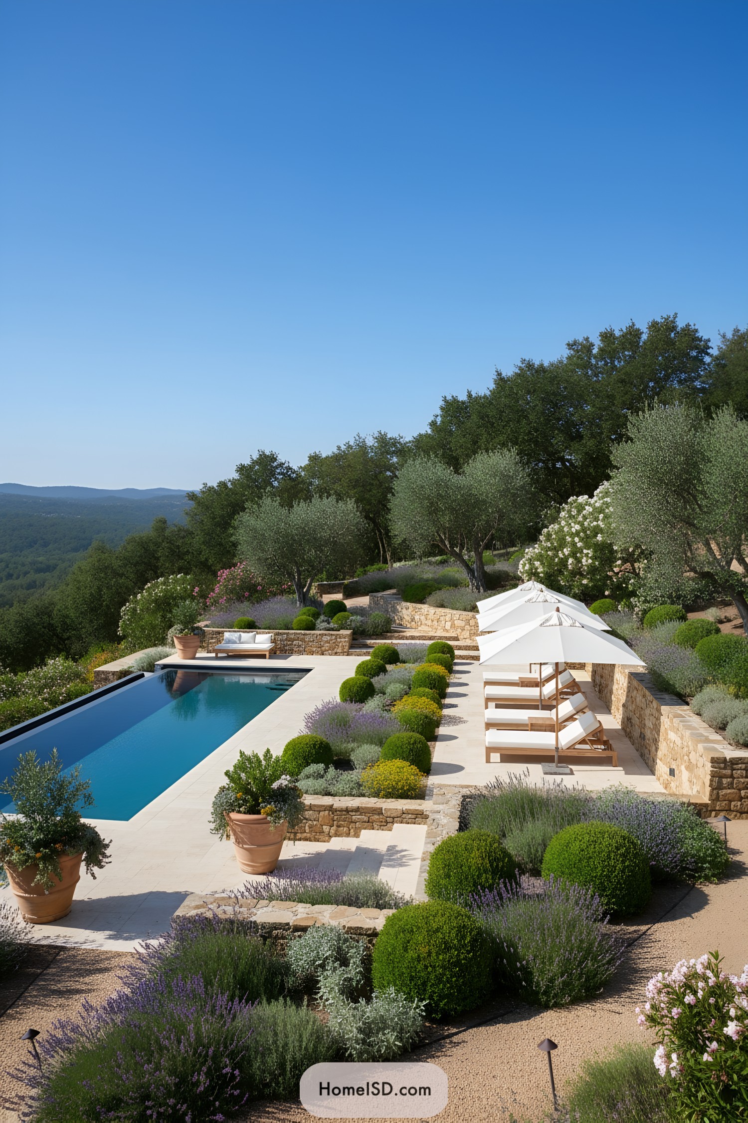 Stone-terraced pool with lavender and loungers