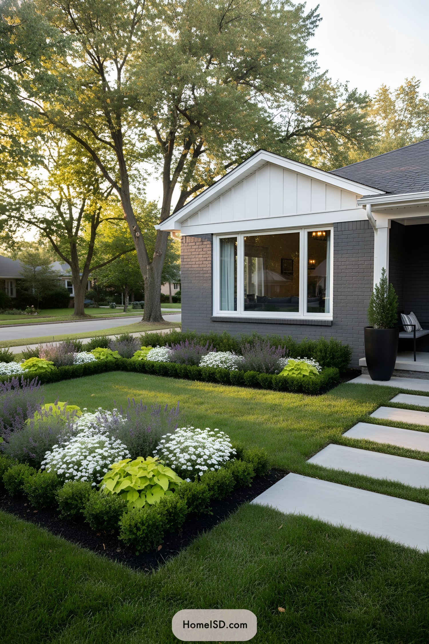 Boxwood parterre front yard with lavender and white blooms, concrete pavers leading to the porch