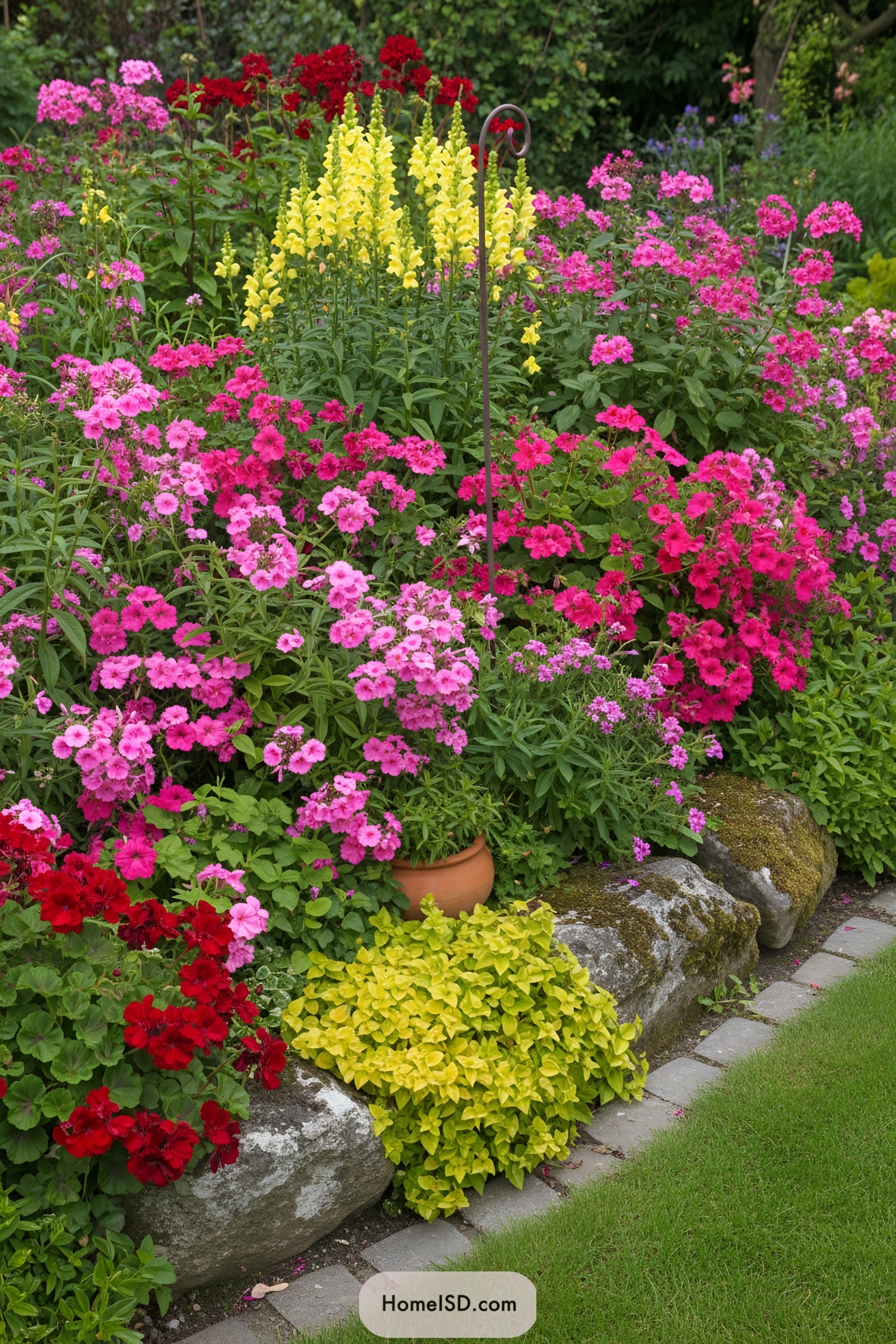 Colorful cottage flower bed with stone edging