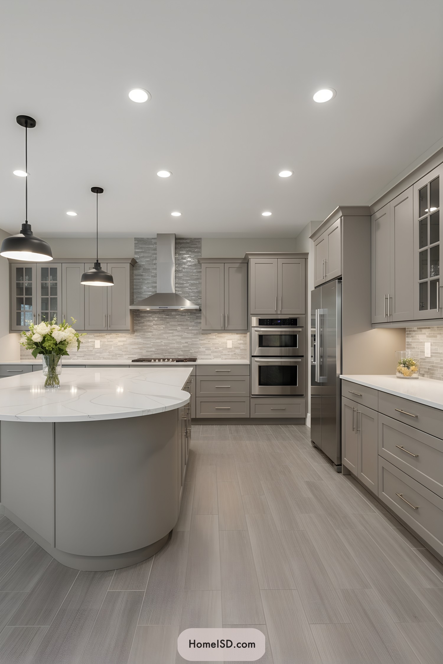 Contemporary gray kitchen with curved island and quartz tops