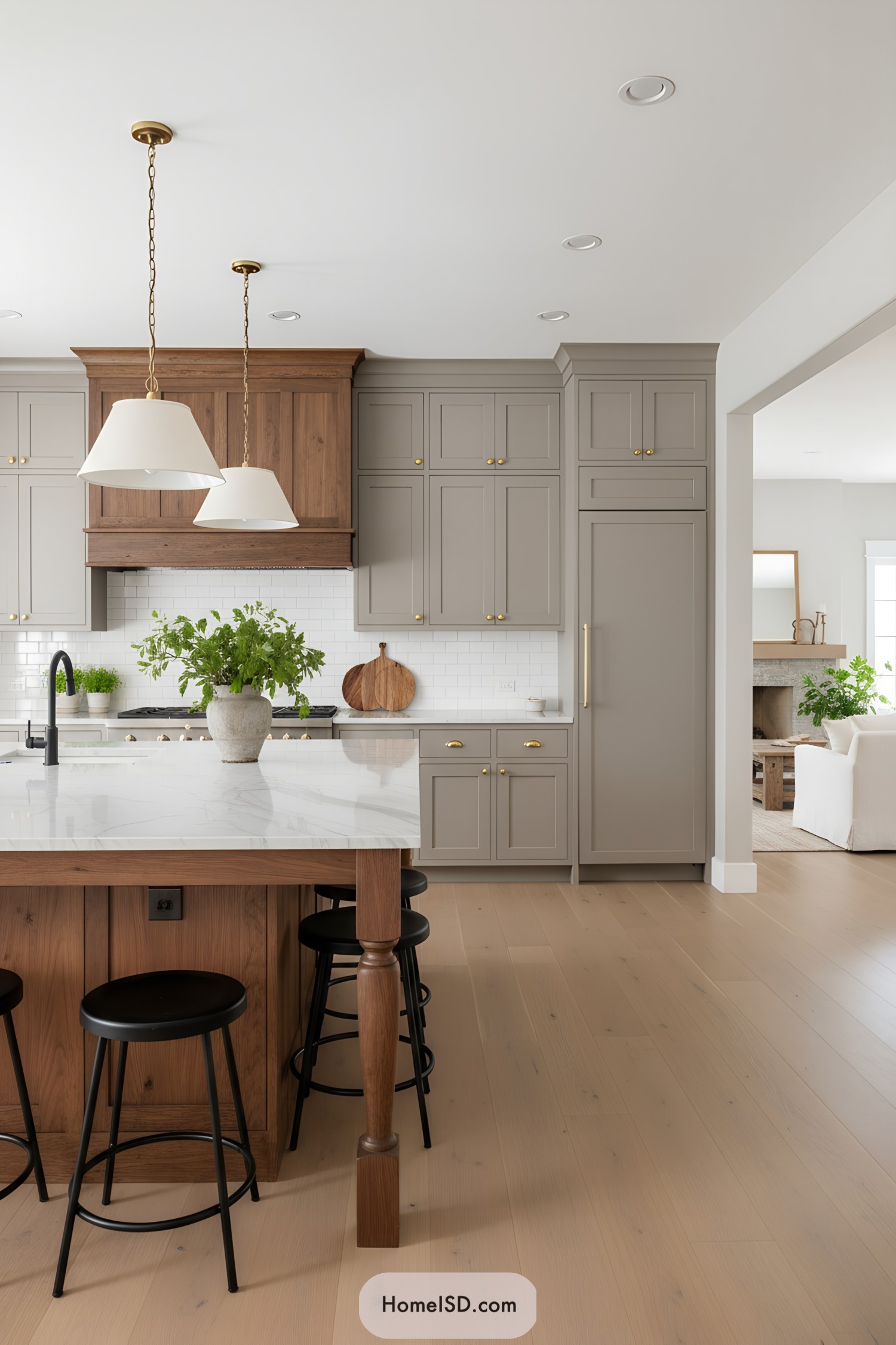 Greige kitchen with walnut island and brass