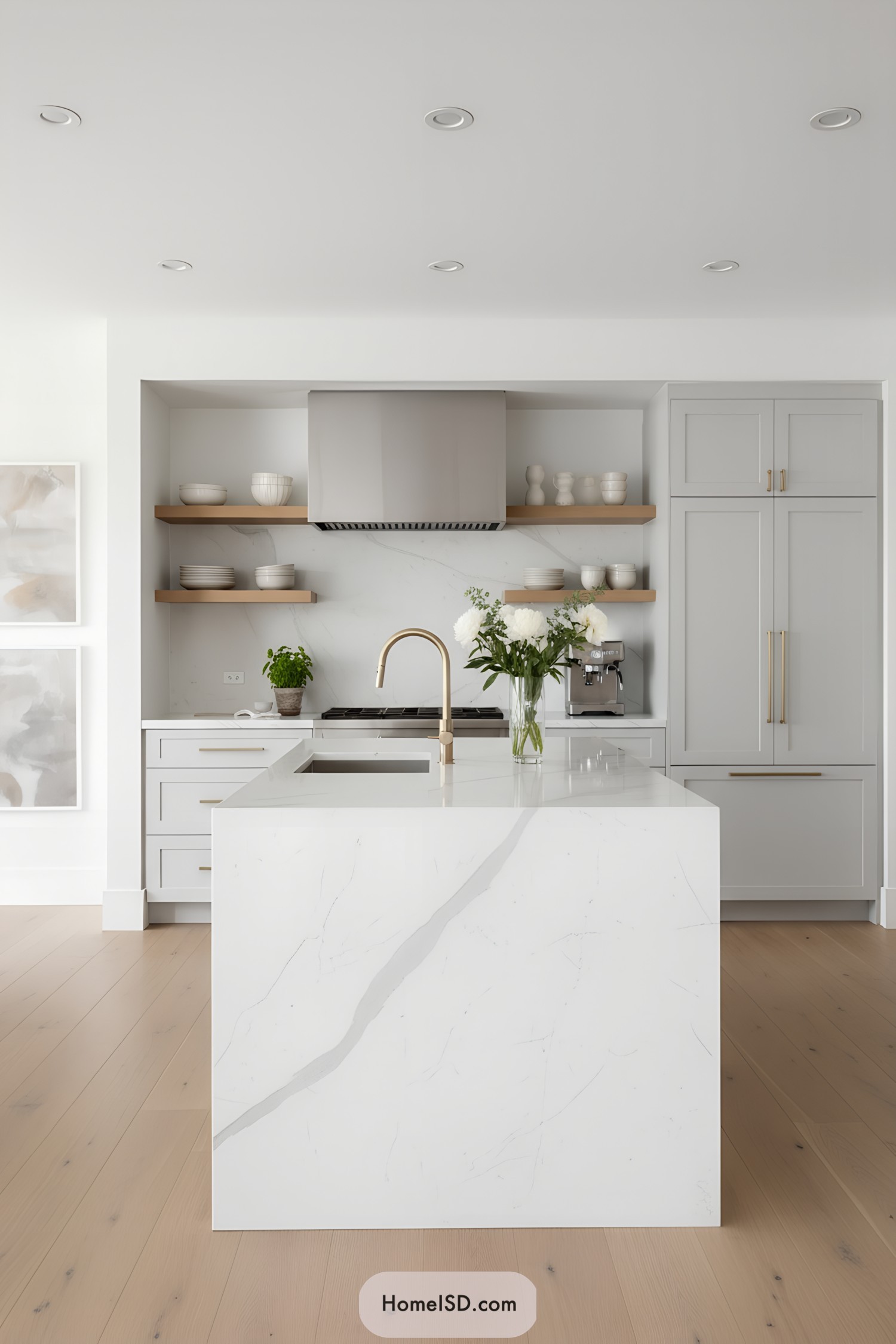 Light gray cabinetry, white waterfall island, brass faucet