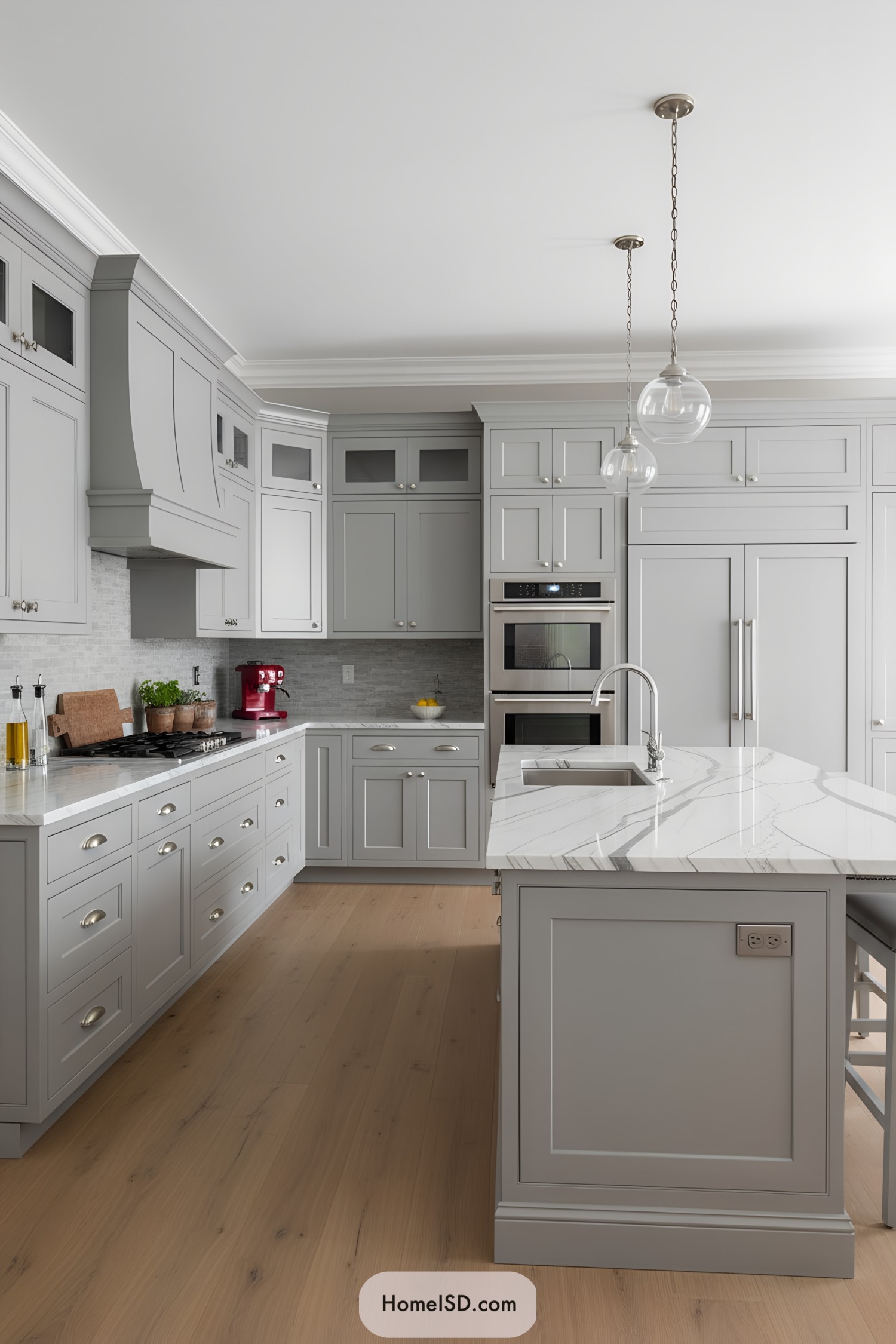 Light gray shaker kitchen with veined marble island