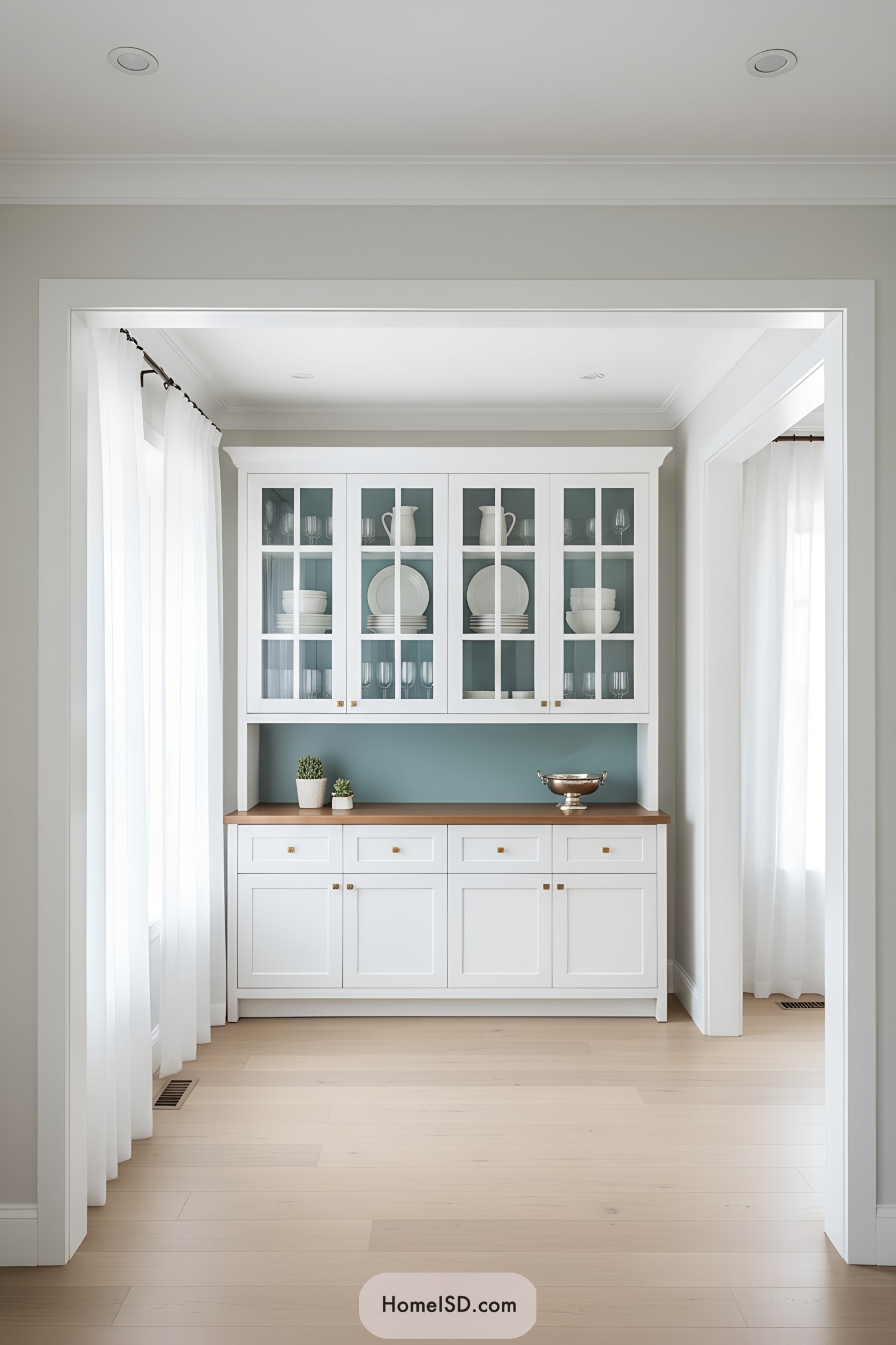 White built-in china cabinet with teal backing