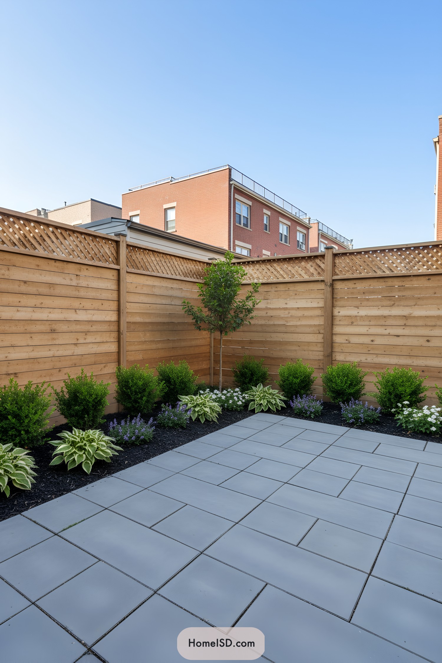 Compact garden with sleek tiled patio and vibrant plants