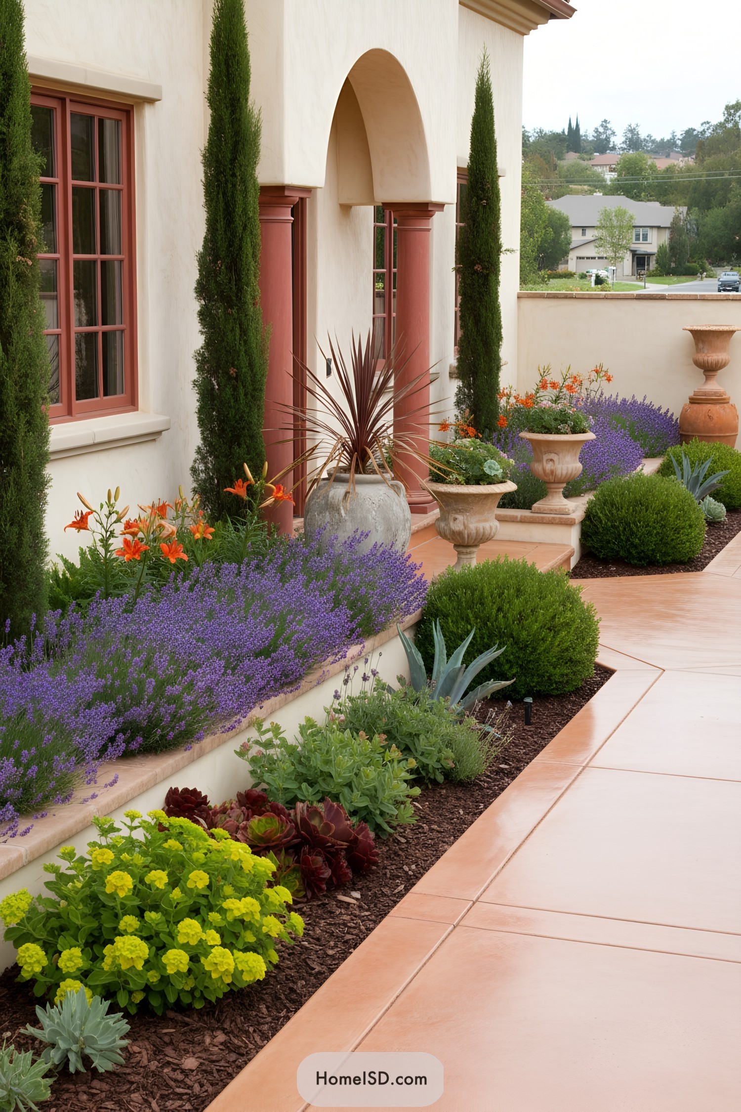 Warm stucco portico with lavender massing, cypress spires, urns, and a terracotta-toned walkway